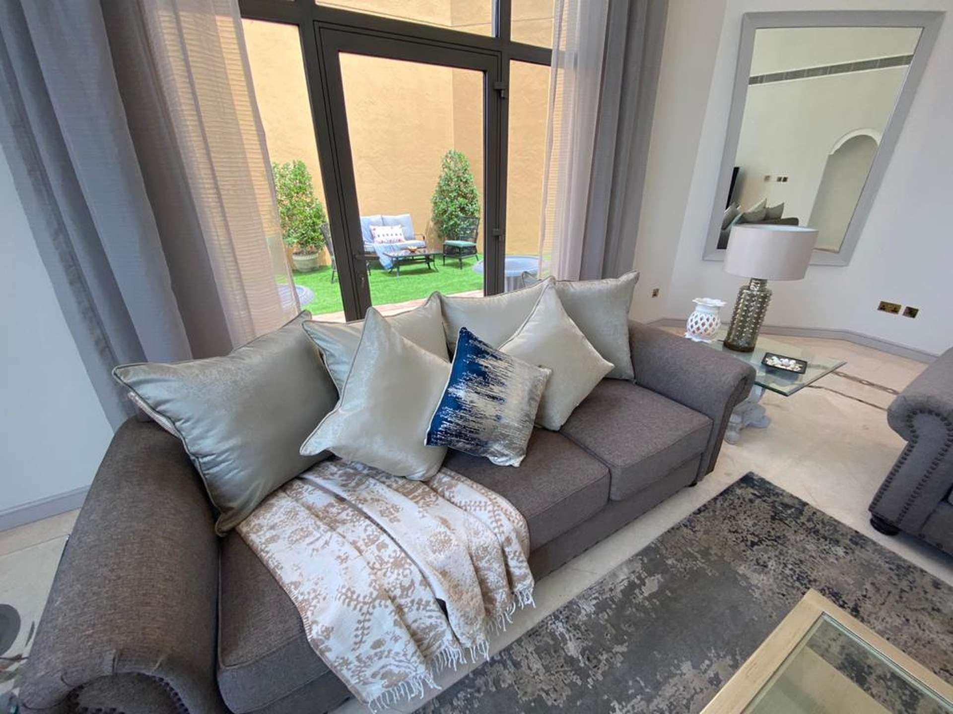 Luxurious living room in Palm Jumeirah villa with stunning garden and water views