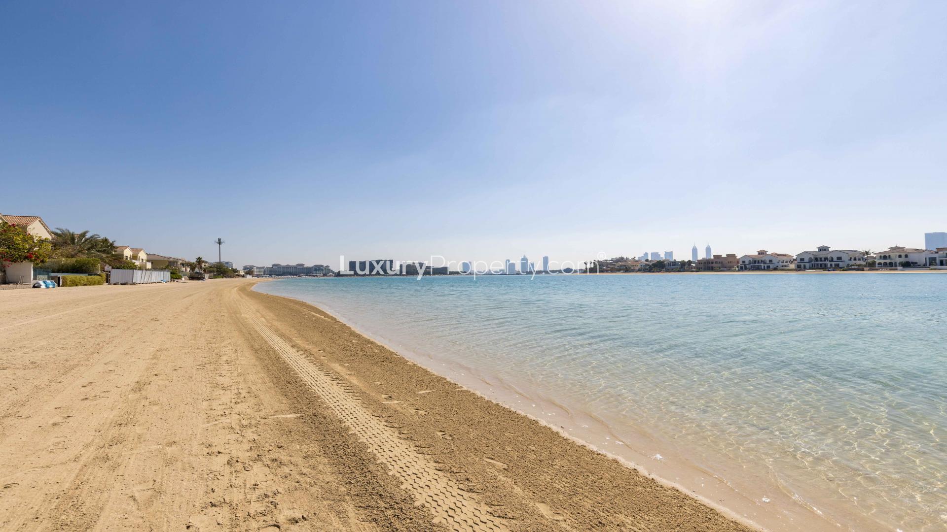 Dining room in furnished Palm Jumeirah villa with vibrant parrot artwork and waterfront view