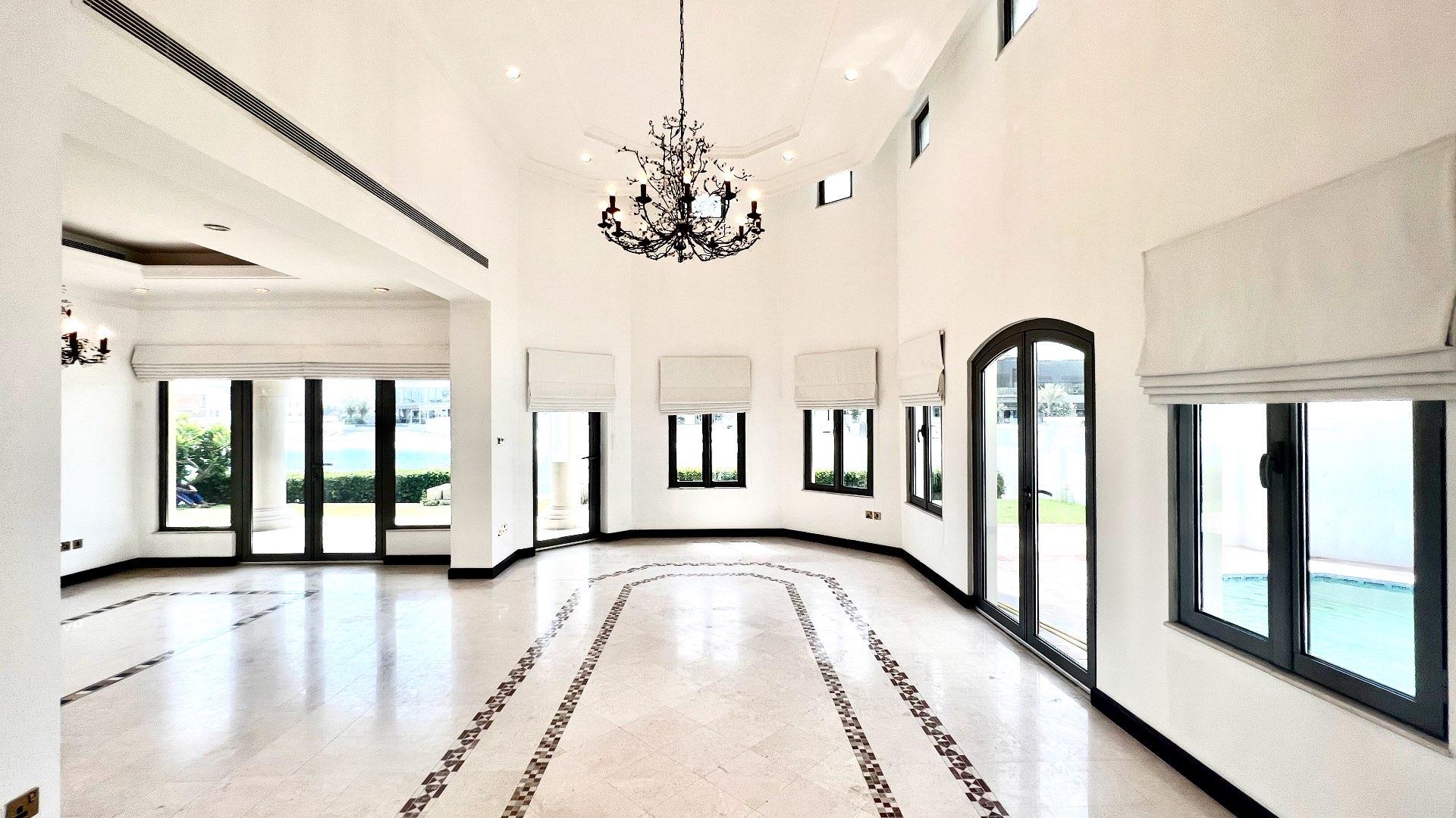 Beautiful garden view from Palm Jumeirah villa overlooking serene waterfront, lush greenery