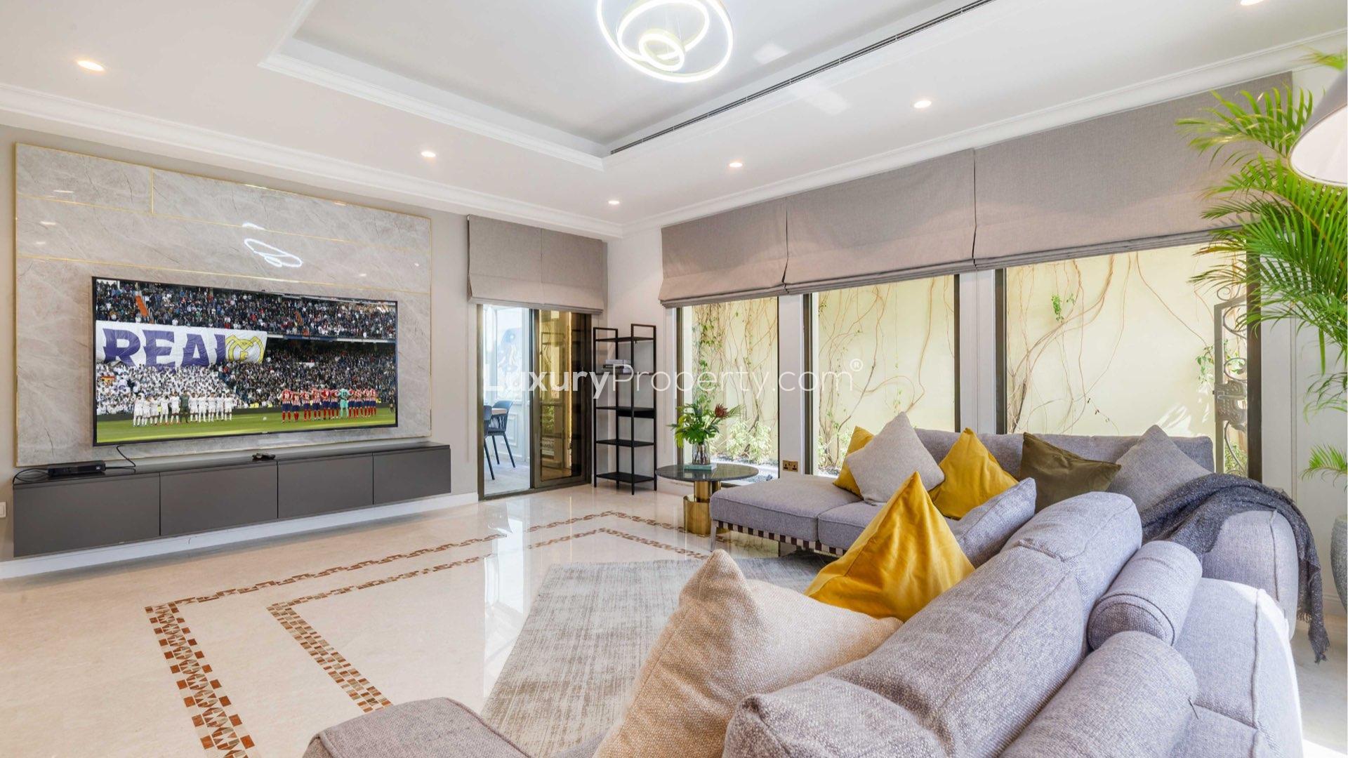 Balcony view from upgraded Palm Jumeirah villa overlooking water and Atlantis at sunset