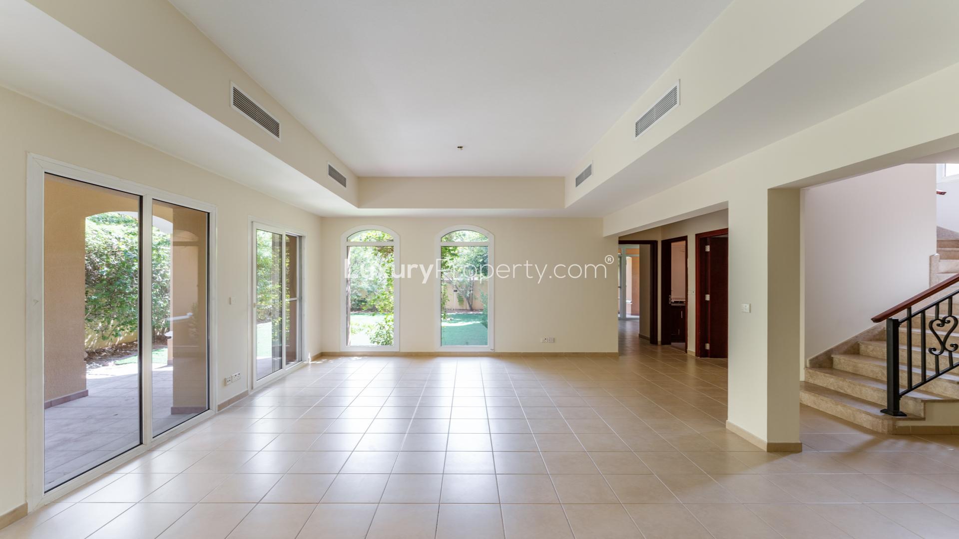 Corner villa exterior with lush garden in Palmera, Arabian Ranches, available for rent