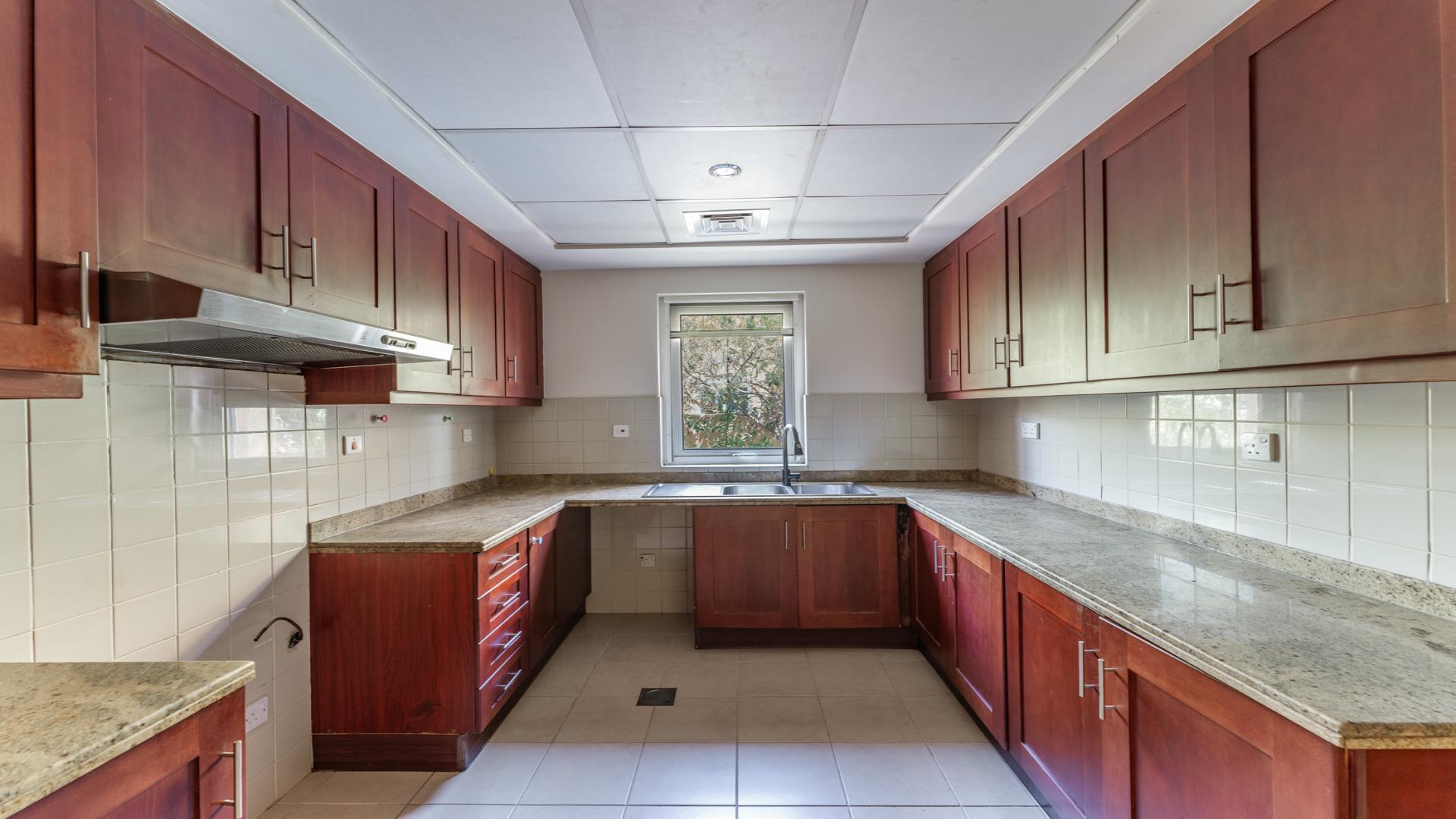 "Bright stairway with window view in 4-bedroom villa, Arabian Ranches, Palmera community.","Spacious kitchen with wooden cabinets in 4-bedroom villa, Arabian Ranches, Palmera, for rent.",Spacious living area in vacant 4-bedroom villa, Arabian Ranches, Palmera community