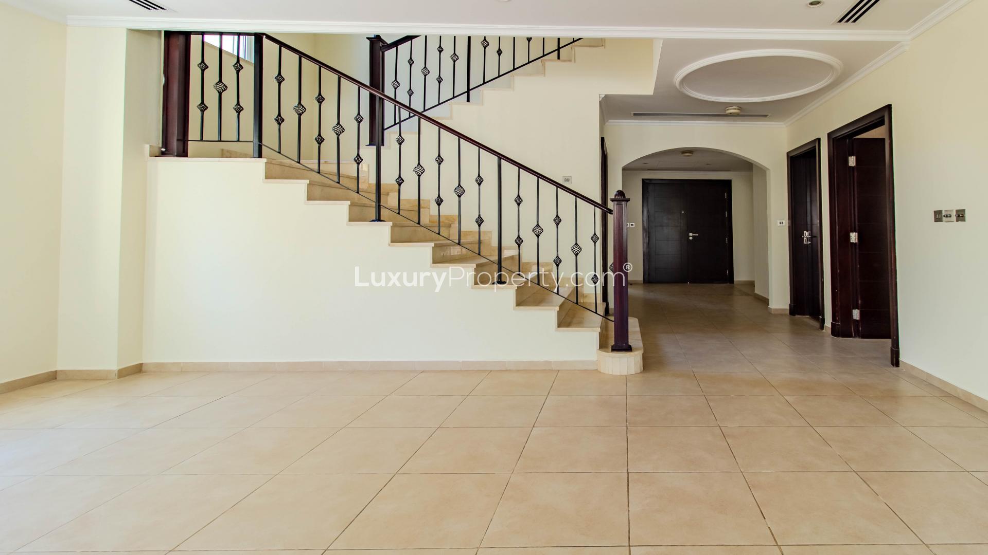 Spacious open-plan living area in Jumeirah Park villa with modern staircase and large windows