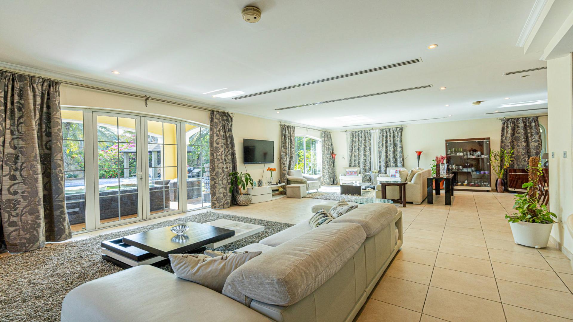 Bright, spacious living area in Jumeirah Park Legacy villa with modern furnishings