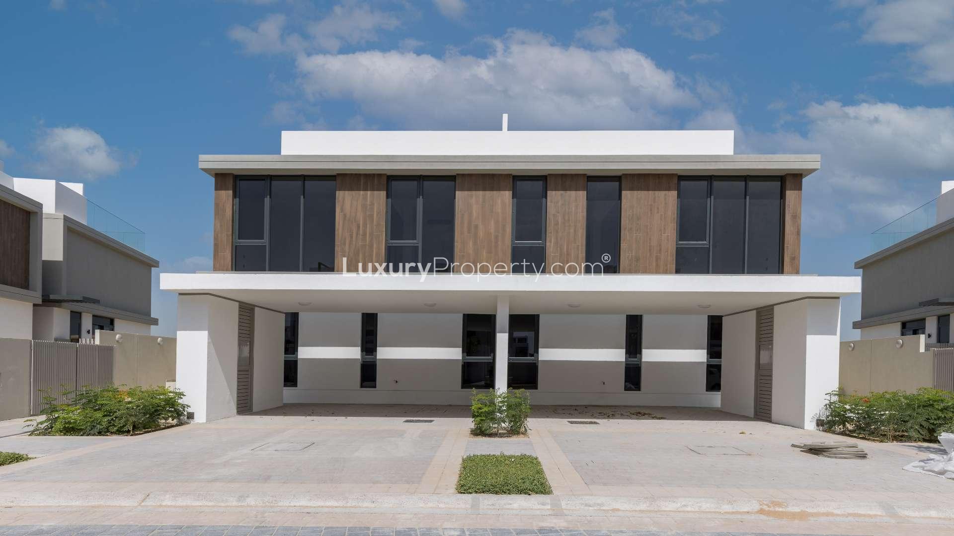 Spacious open-plan living area in Dubai Hills Estate villa, modern kitchen and staircase