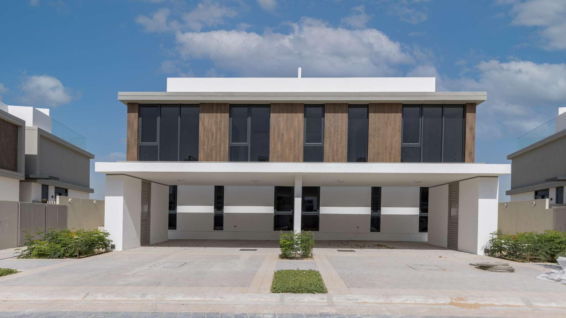 Spacious open-plan living area in Dubai Hills Estate villa, modern kitchen and staircase