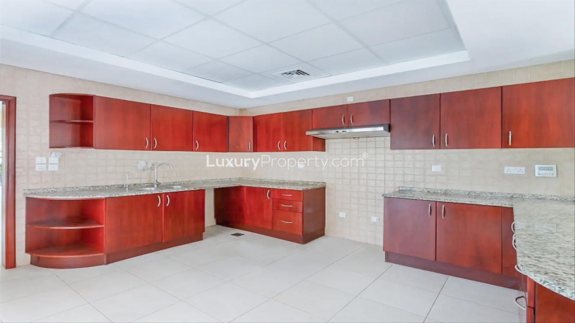 Spacious living room in 4-bedroom villa, Green Community West, Dubai, with garden view