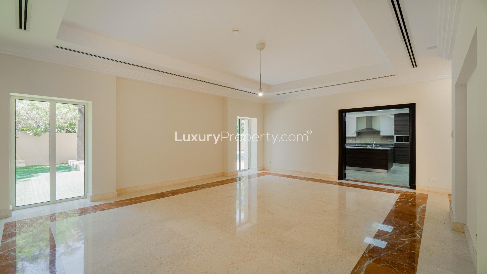 Outdoor pool at Hattan Villa for rent in Arabian Ranches, lush greenery surrounds