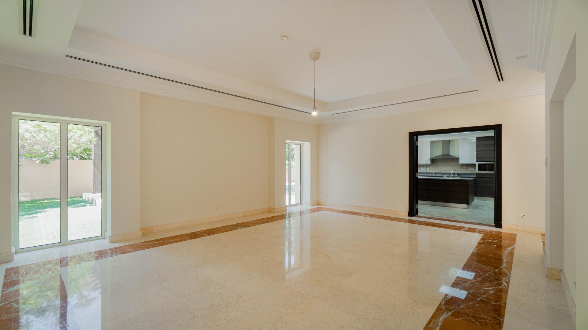 Outdoor pool at Hattan Villa for rent in Arabian Ranches, lush greenery surrounds