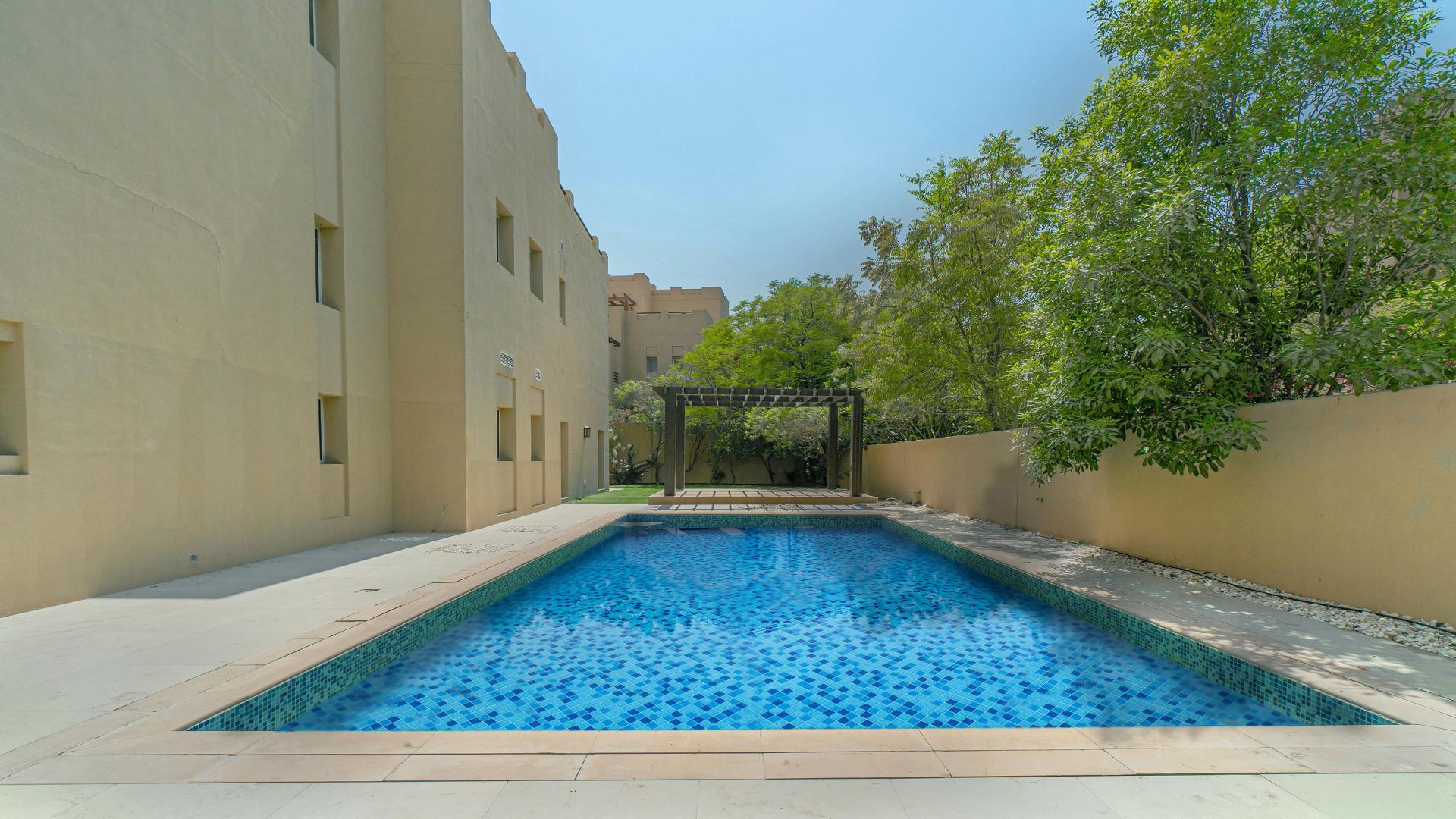 Spacious living area in Hattan Villa, Arabian Ranches, with marble flooring and garden view