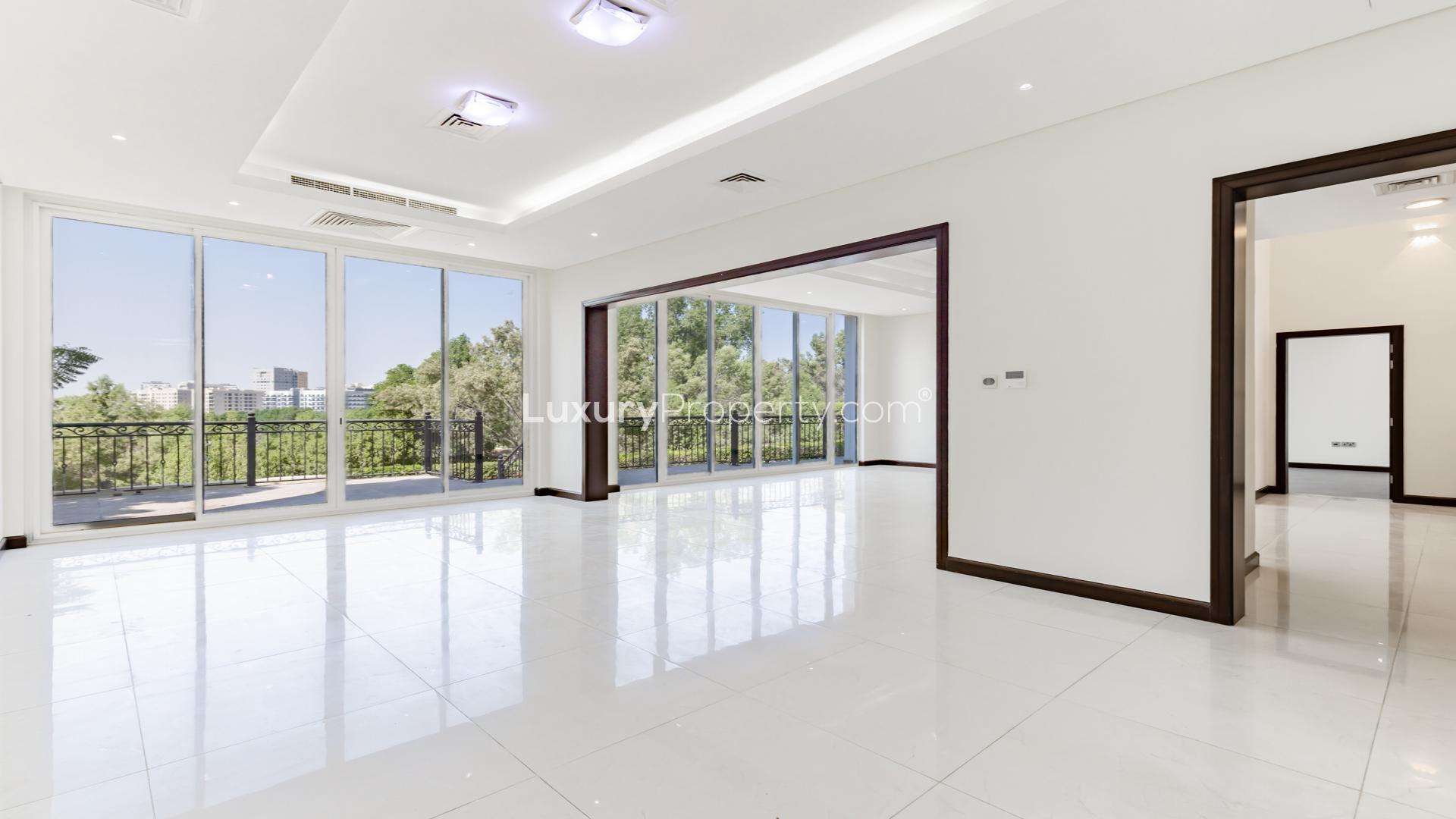 "Luxury villa with private pool, Jumeirah Golf Estates, Earth community, for rent.","Spacious villa interior with large windows overlooking lush golf course, Jumeirah Golf Estates.",Beautiful custom-built villa exterior with garage, Jumeirah Golf Estates, Earth community