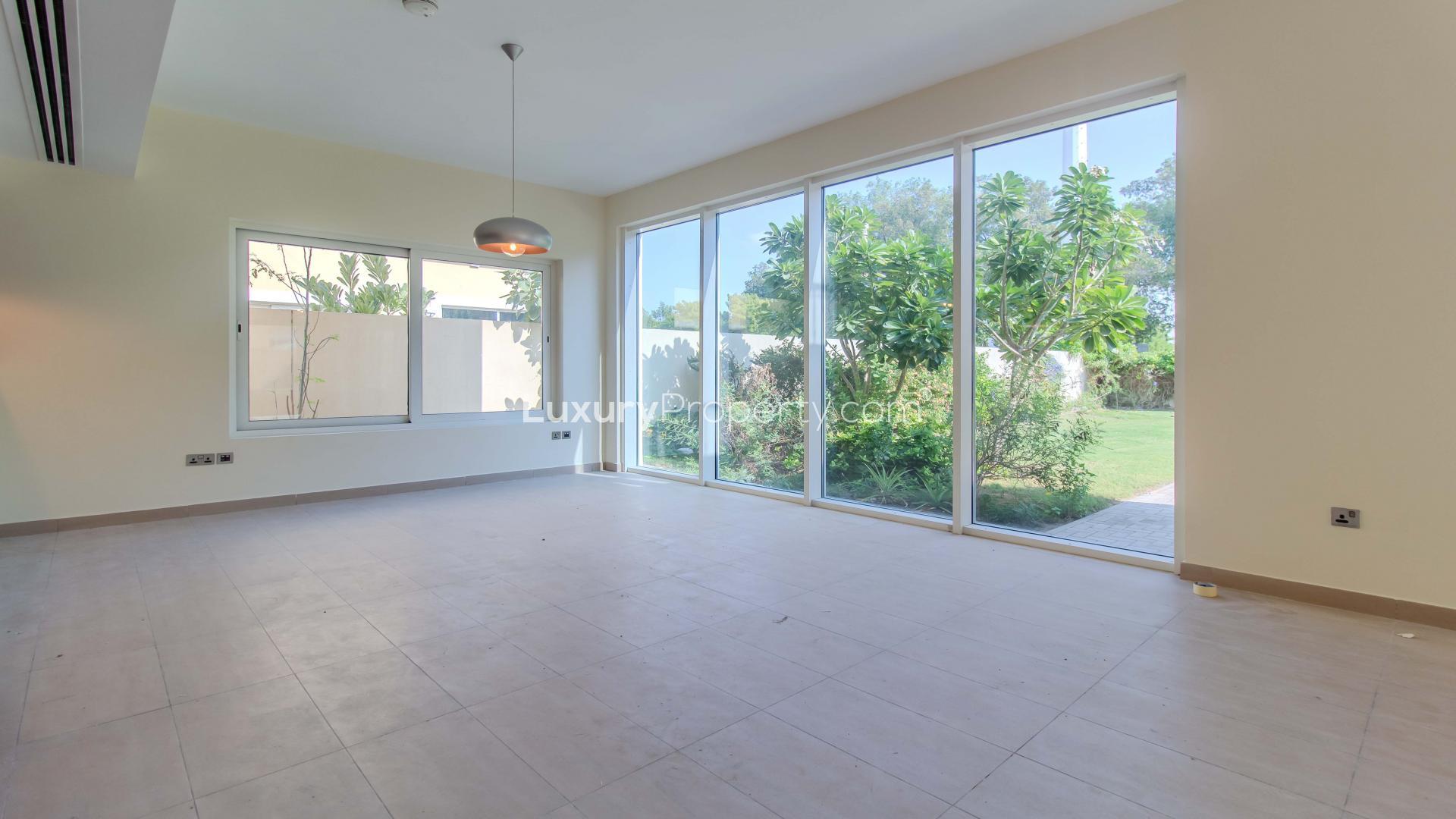 Spacious villa interior with large windows overlooking landscaped garden, Legacy Nova Villas, Jumeirah Park