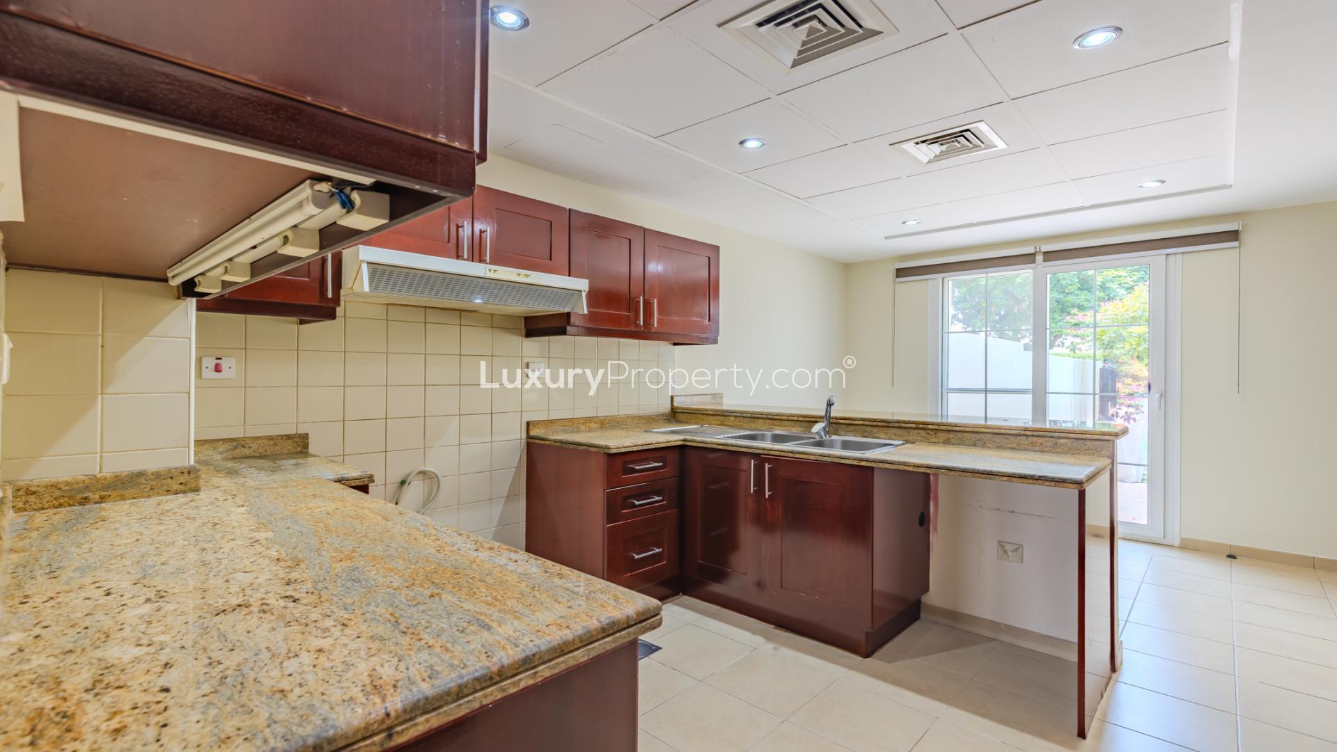 Spacious living room with large windows in Arabian Ranches villa, Al Reem community