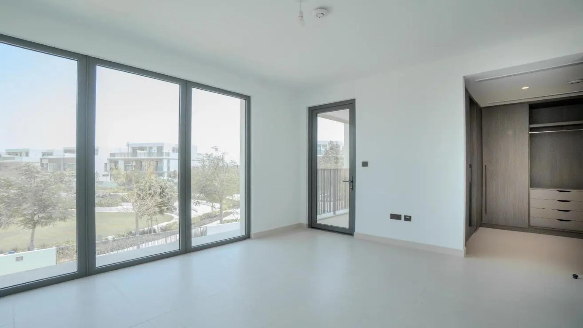 Modern kitchen in Tilal Al Ghaf villa, featuring sleek cabinetry and built-in appliances
