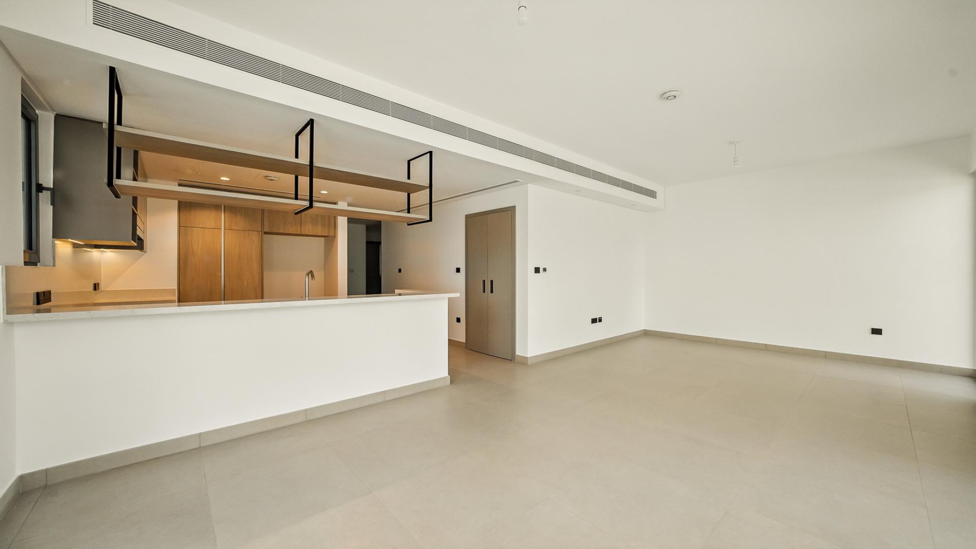 Modern kitchen and spacious living area in Tilal Al Ghaf Aura Gardens villa for rent