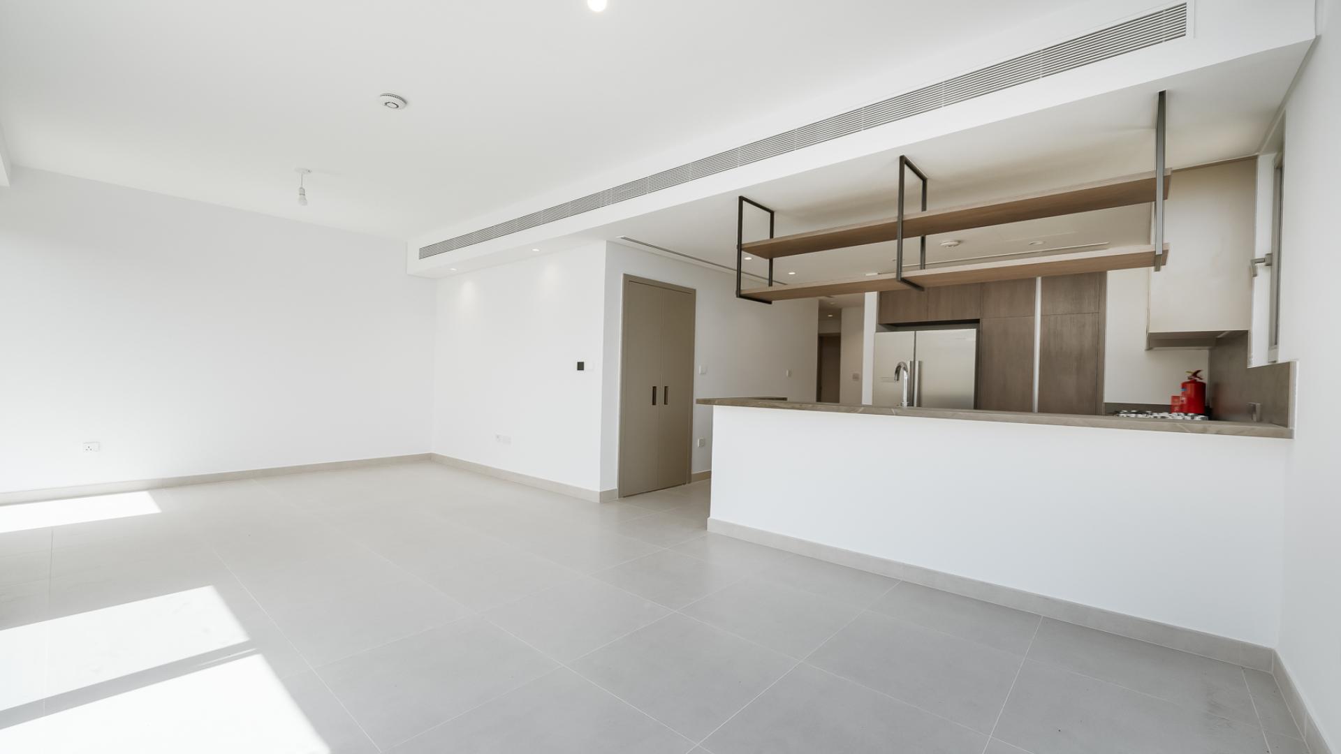 Modern kitchen and living area in Aura Gardens villa, Tilal Al Ghaf, available for rent
