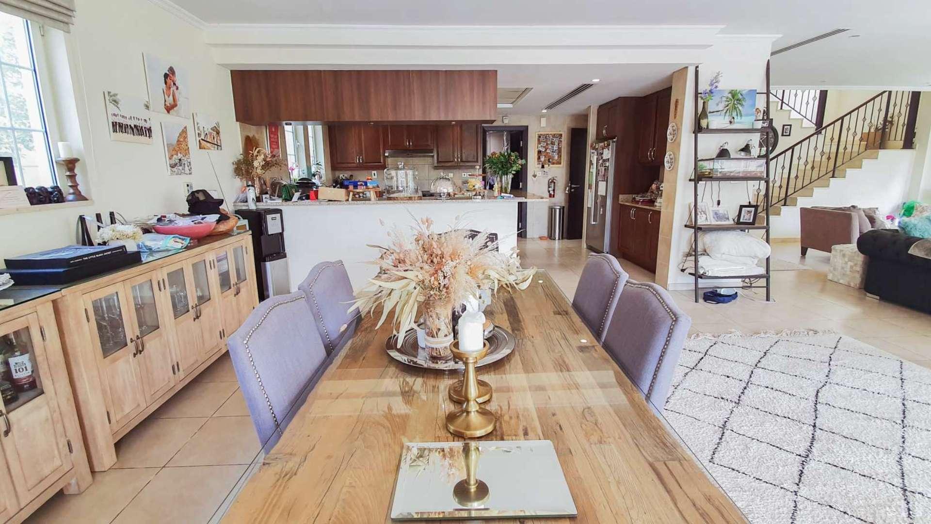 Living room in Jumeirah Park villa with cozy seating and large TV