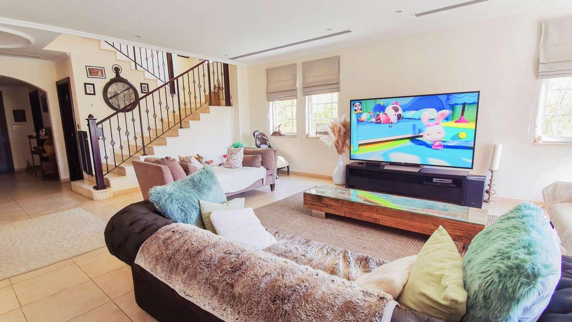 Living room in 4-bedroom villa, Jumeirah Park Legacy, featuring modern decor and open layout