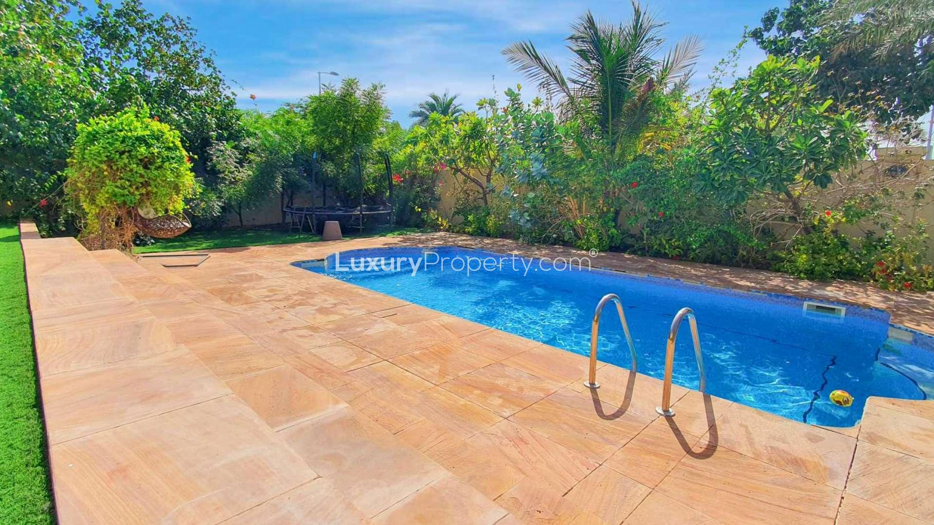 Private pool in Jumeirah Park Legacy villa for rent, surrounded by lush greenery