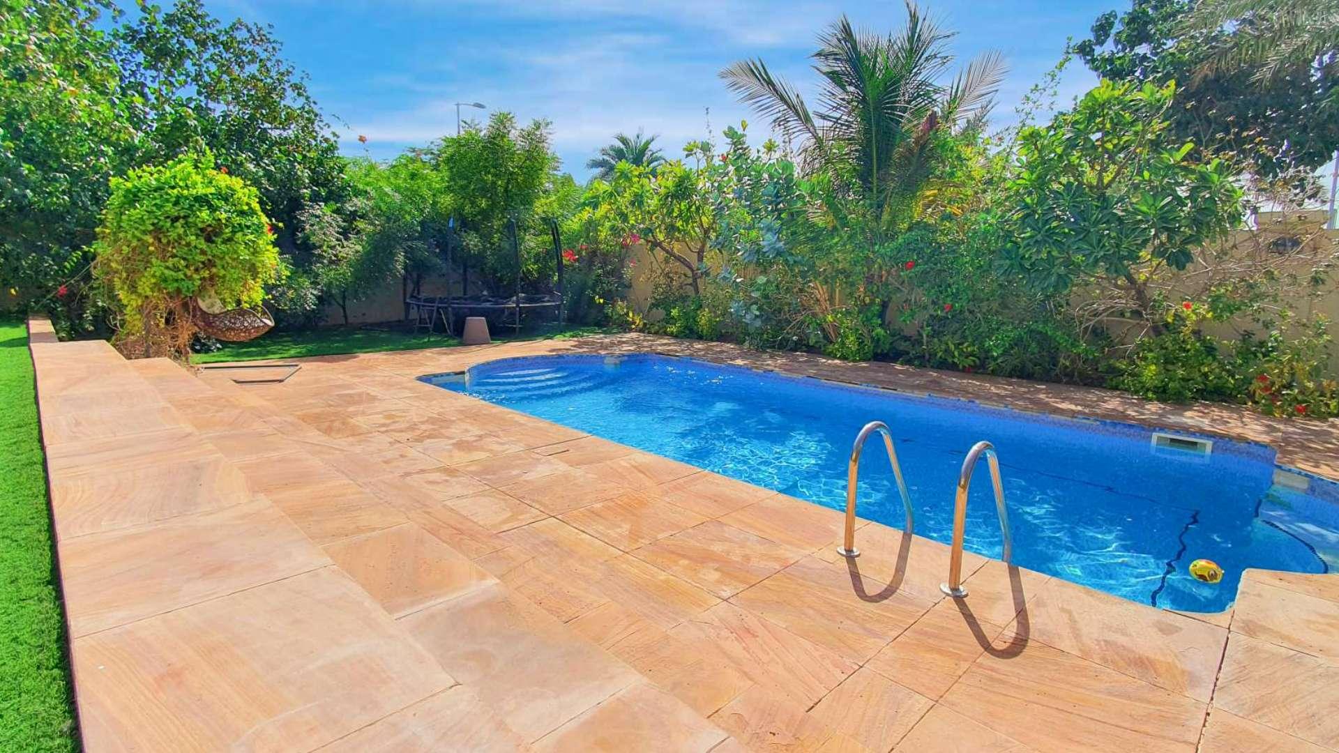 Private pool in Jumeirah Park Legacy villa for rent, surrounded by lush greenery