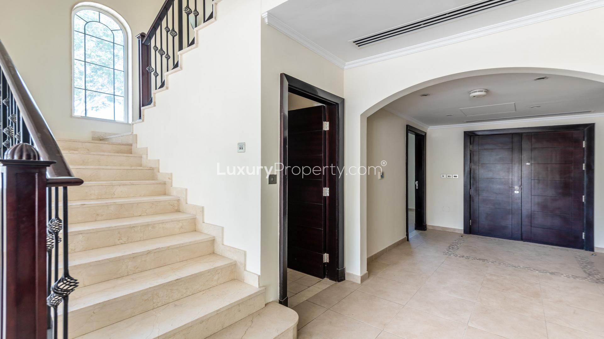 Luxurious Jumeirah Park villa with private pool, spacious lawn, and elegant architecture for rent