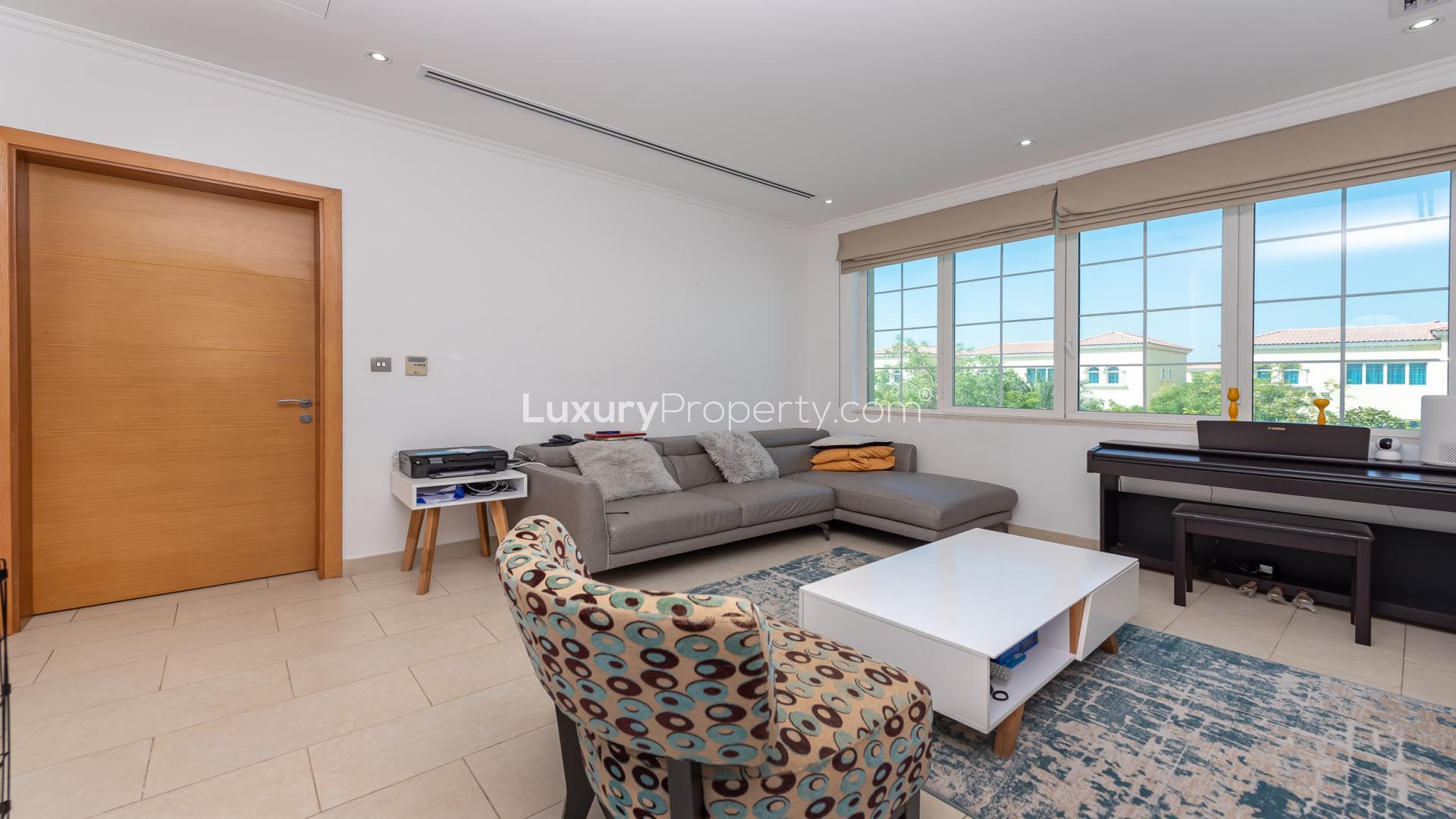Spacious bedroom in 4-bedroom Legacy Villa, Jumeirah Park, featuring large windows and modern decor