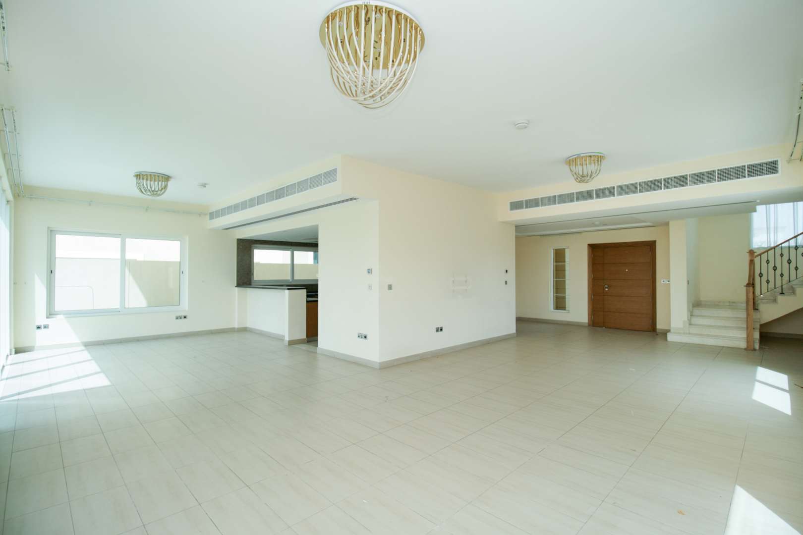 "Spacious living room in 4-bedroom Legacy Nova Villa, Jumeirah Park for sale.",Open-plan living area in Legacy Nova Villa, Jumeirah Park, with staircase and large windows