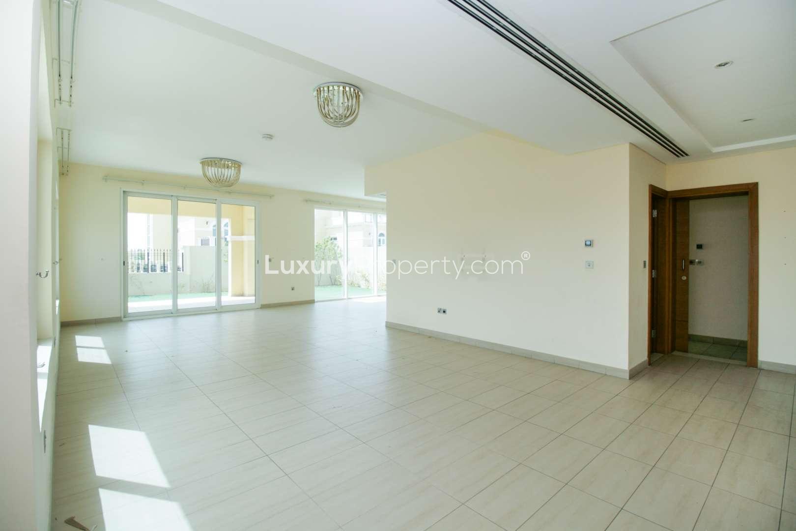 Spacious living area in 4-bedroom Legacy Nova Villa, Jumeirah Park, with large windows and staircase