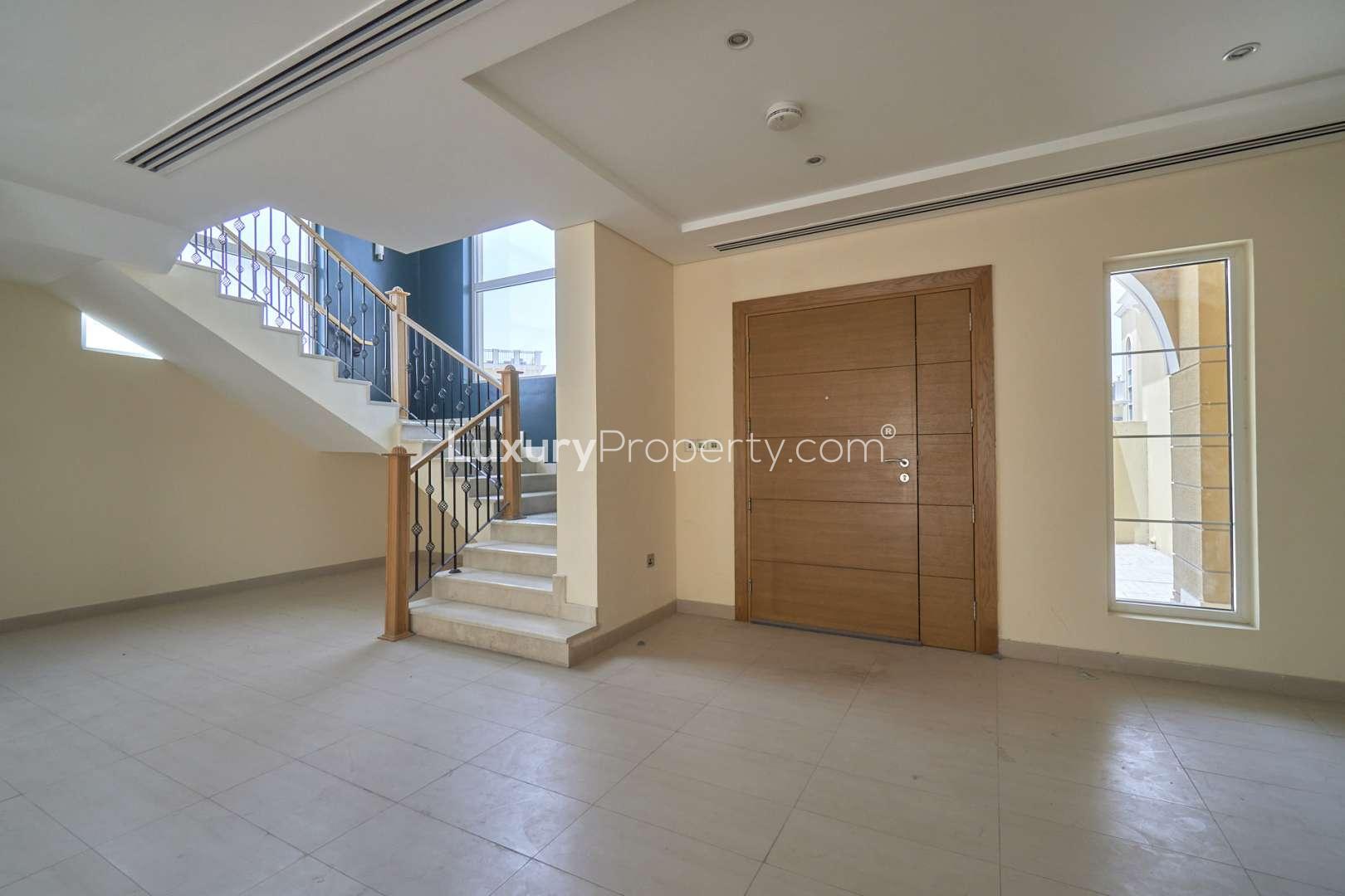 4-Bedroom Legacy Nova Villa exterior in Jumeirah Park, showcasing driveway and lush surroundings