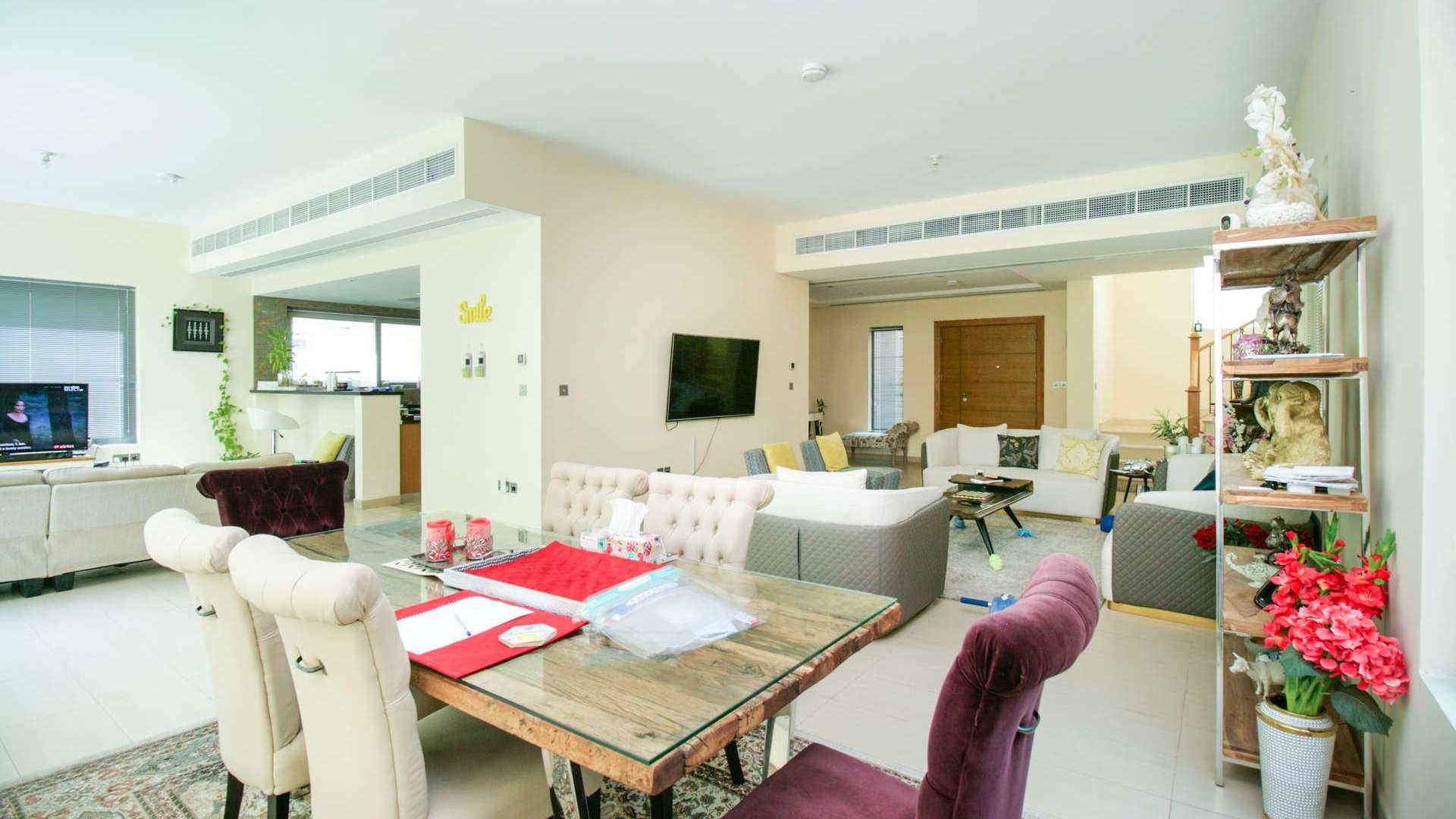 Spacious living room in Legacy Nova Villa, Jumeirah Park, with modern decor and seating