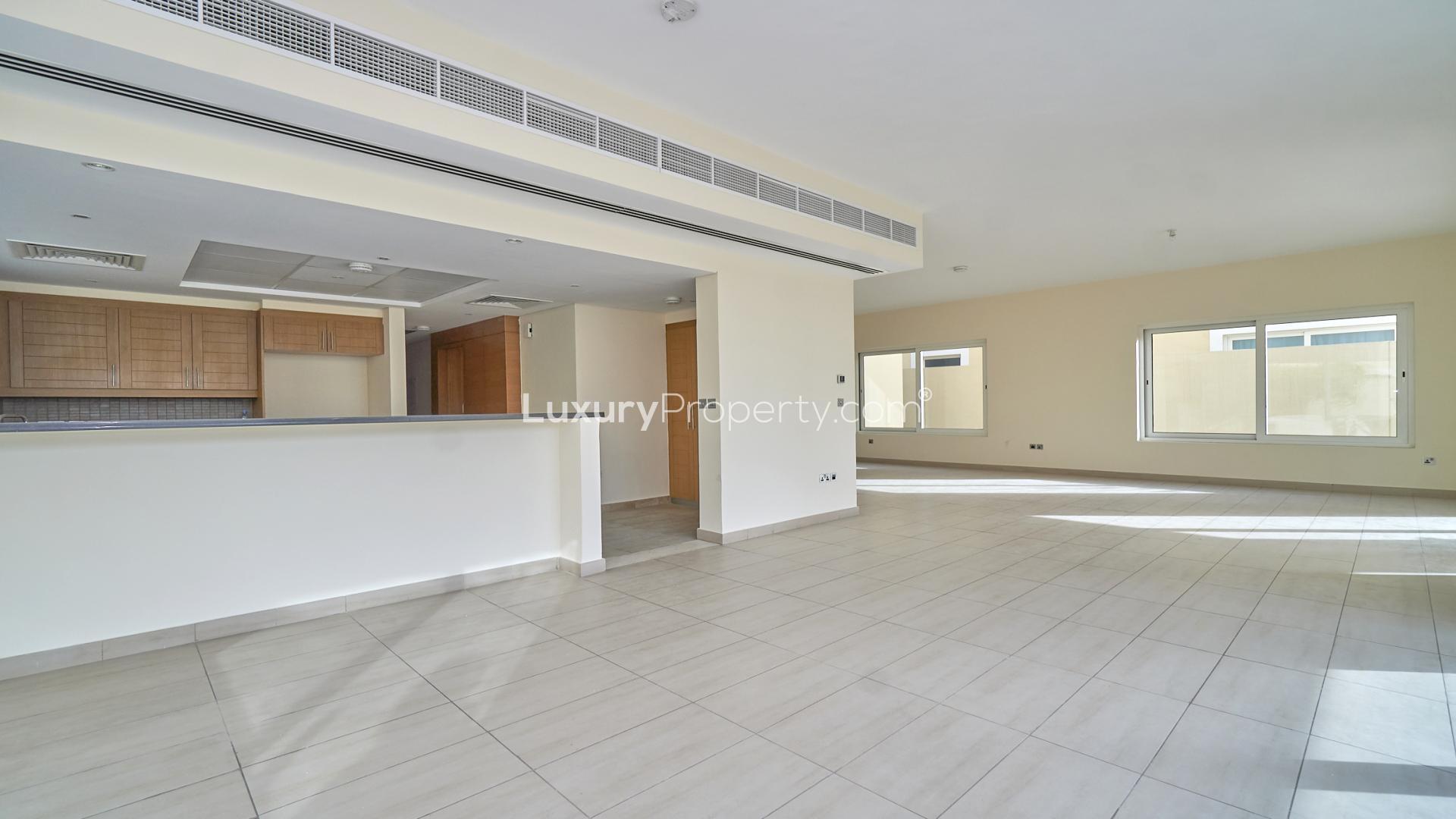Modern kitchen in 4-bedroom Legacy Nova Villa, Jumeirah Park, Dubai, featuring ample natural light