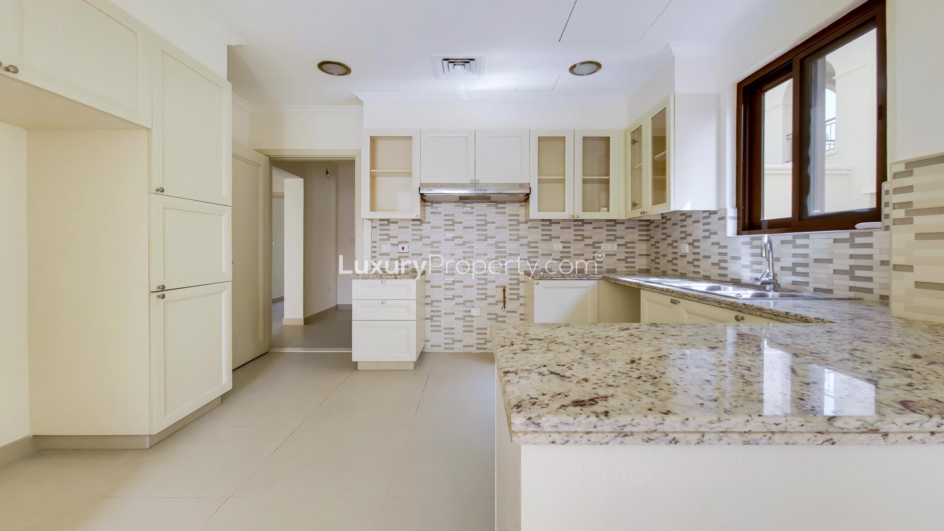 Modern kitchen in single row villa, Arabian Ranches 2, Lila. Spacious countertops, elegant design