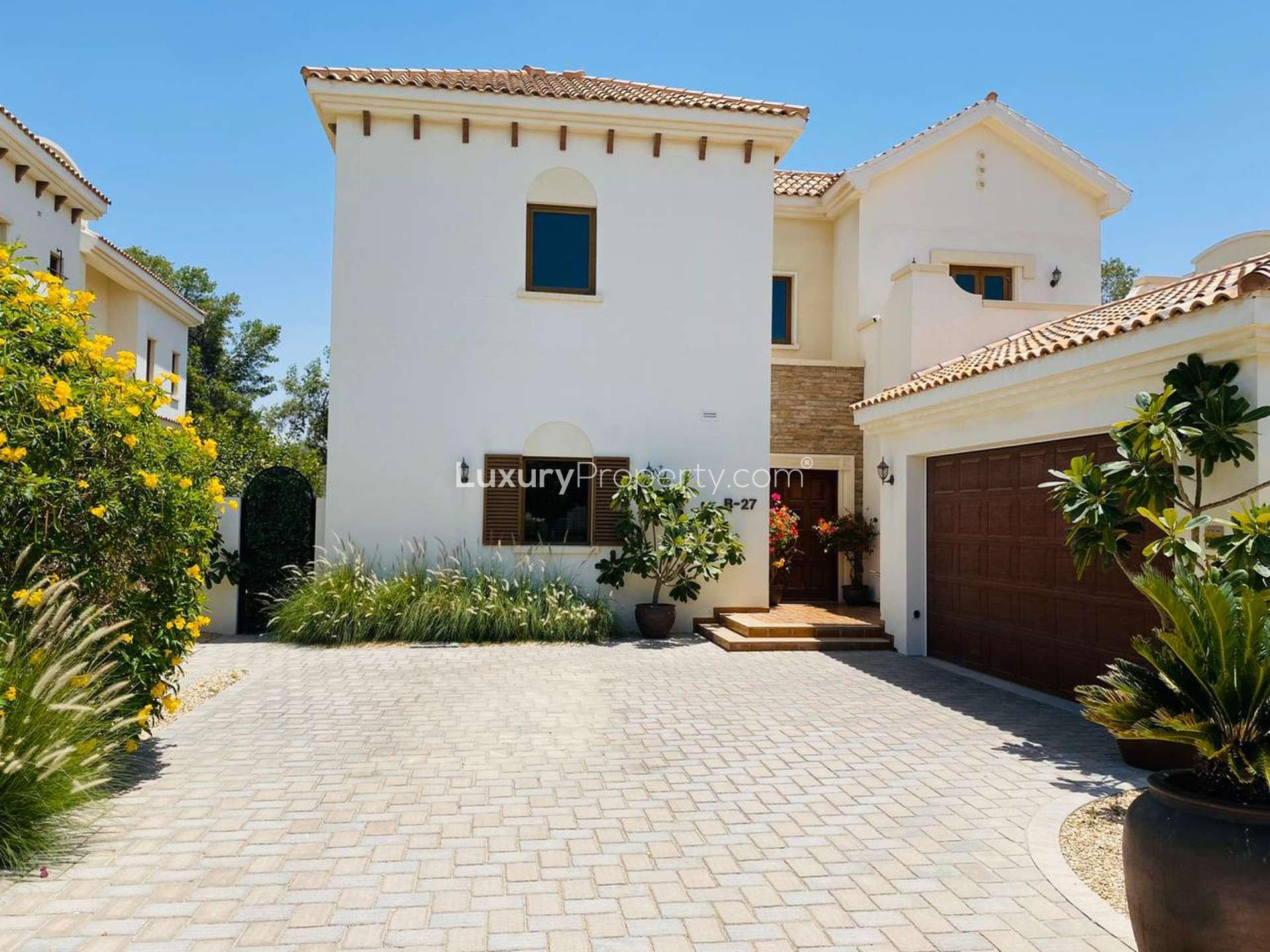 Bright living room in Zaragoza Villa, Jumeirah Golf Estates, with garden views and elegant decor