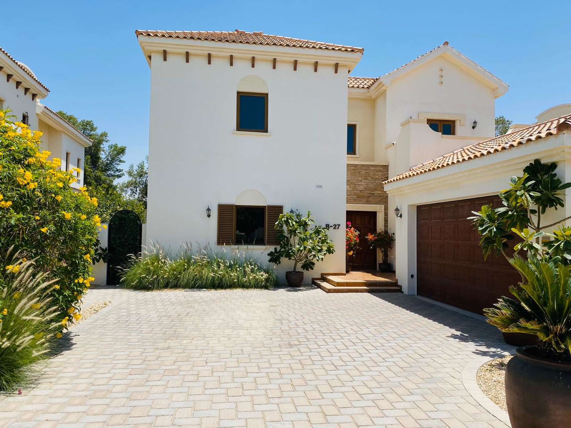 Bright living room in Zaragoza Villa, Jumeirah Golf Estates, with garden views and elegant decor