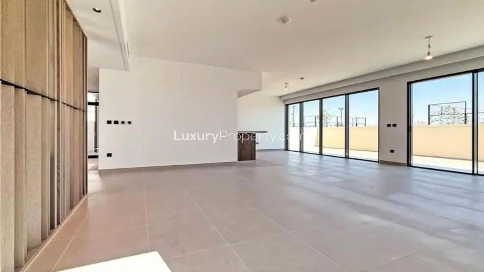 "Bright open-plan living area in stylish villa, Harmony 3, Tilal Al Ghaf for rent.",Spacious living area with large windows in Harmony 3 villa, Tilal Al Ghaf