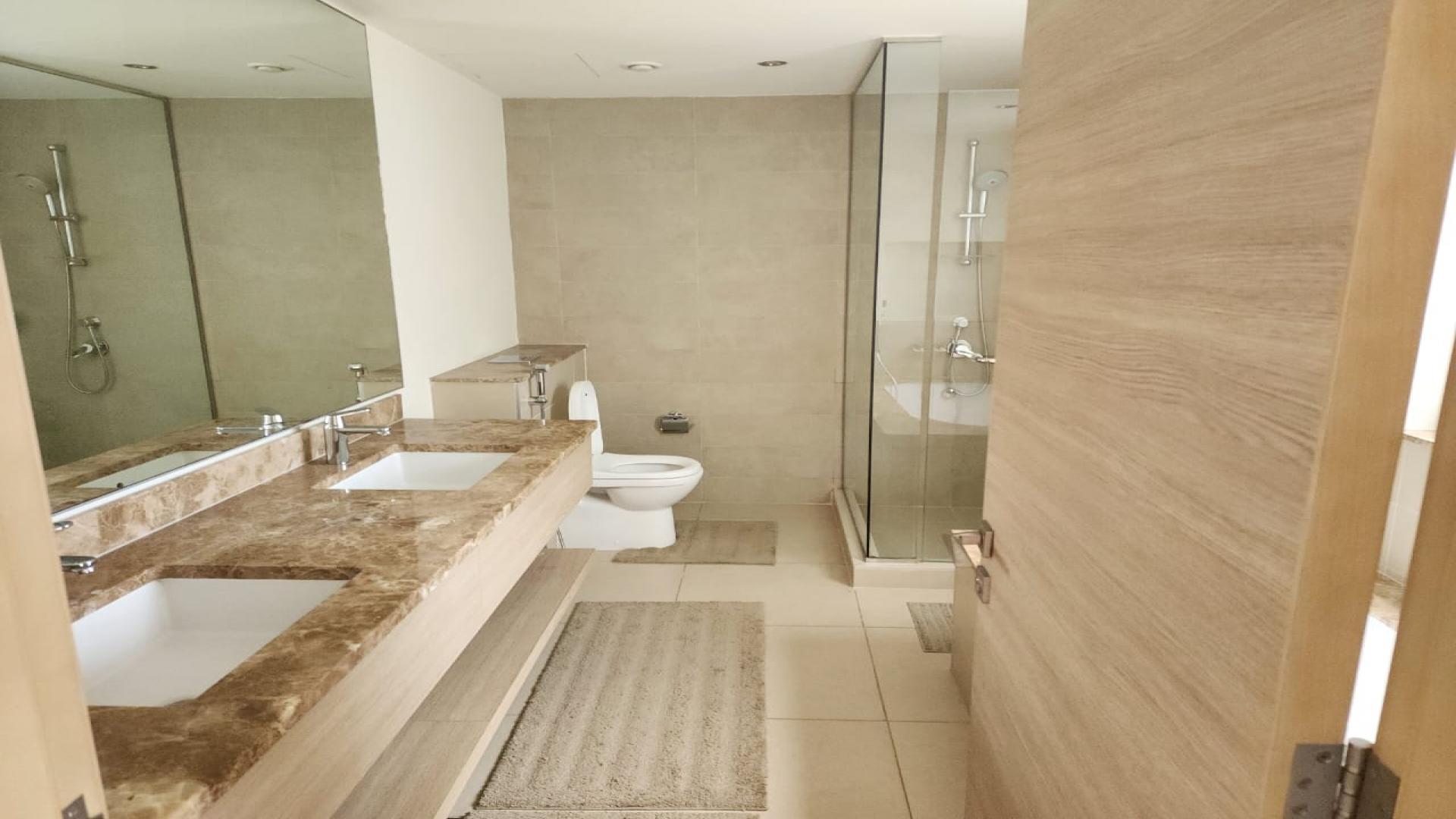 Bright bedroom with large windows and balcony view in Sidra Villas, Dubai Hills Estate