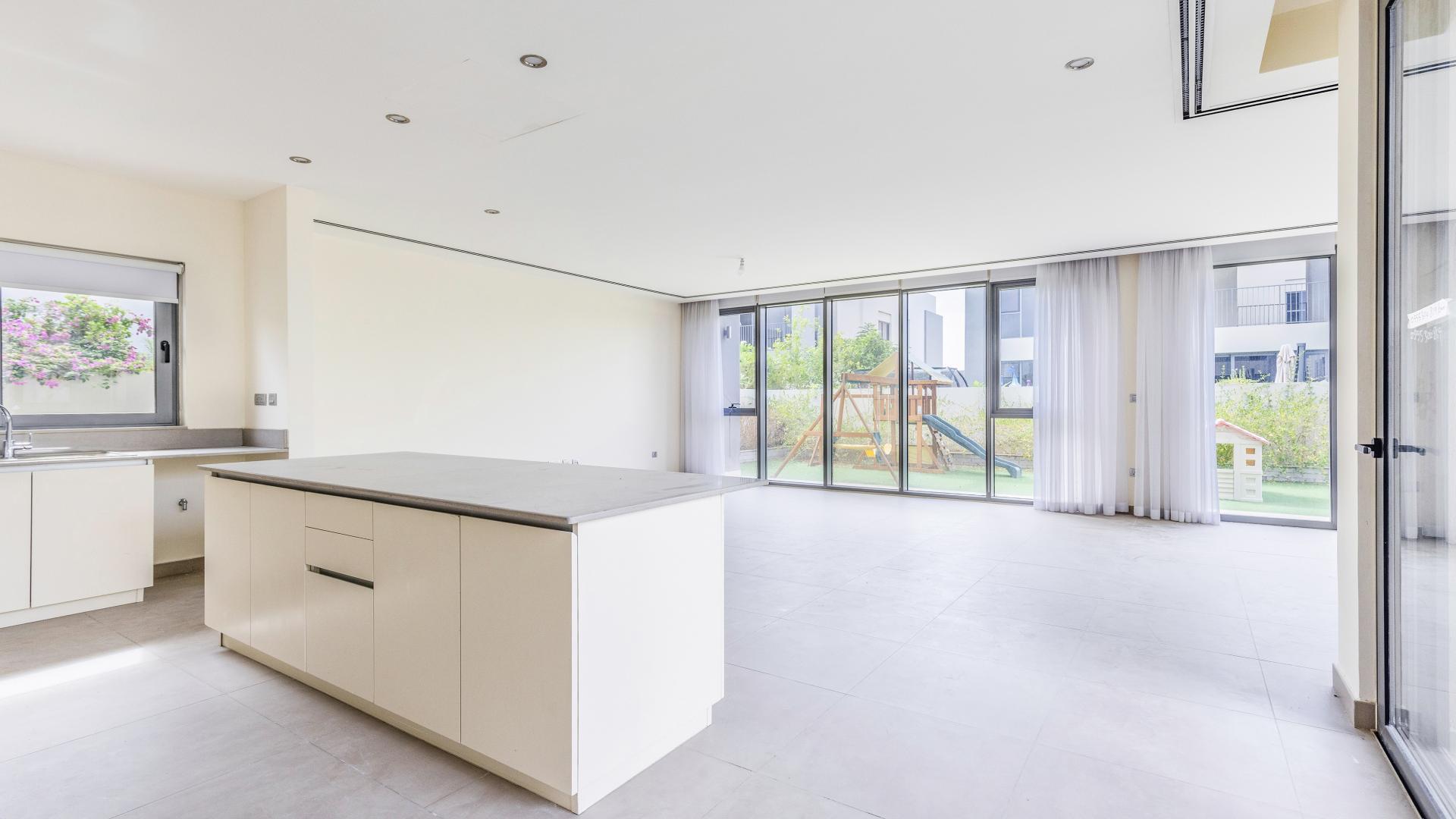 Modern open-plan kitchen and living area in Dubai Hills Estate villa for rent