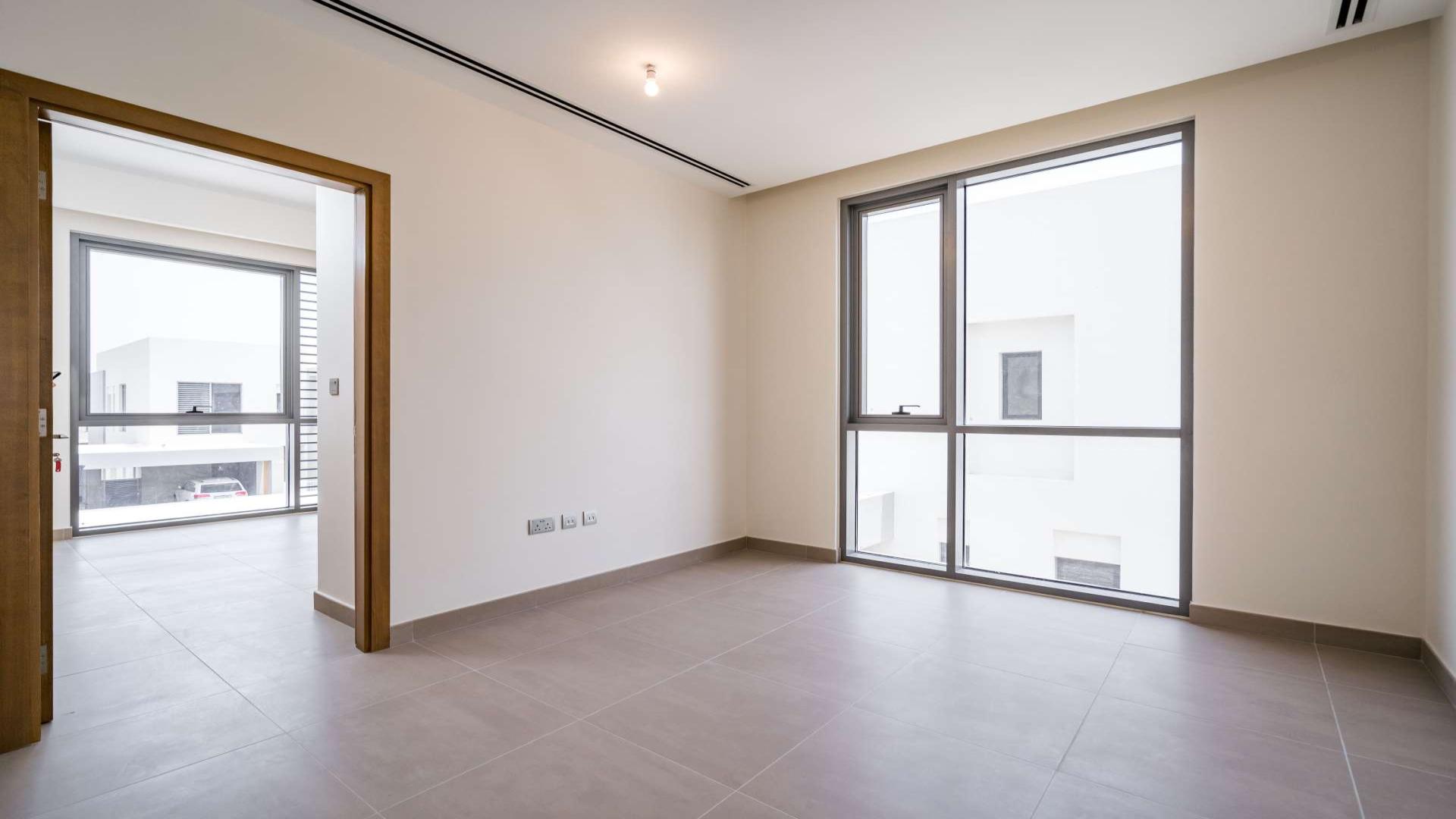 "Bright interior of 4-bedroom villa in Sidra 2, Dubai Hills Estate, with modern finishes.",Empty room with large windows in Sidra 2 villa, Dubai Hills Estate
