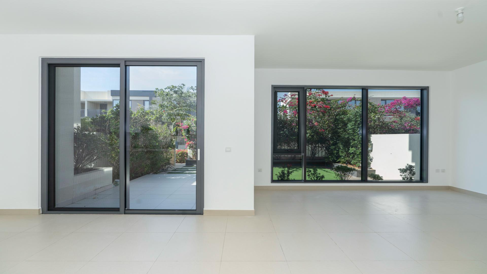 Exterior view of villa garden in Maple 2, Dubai Hills Estate, with lush greenery