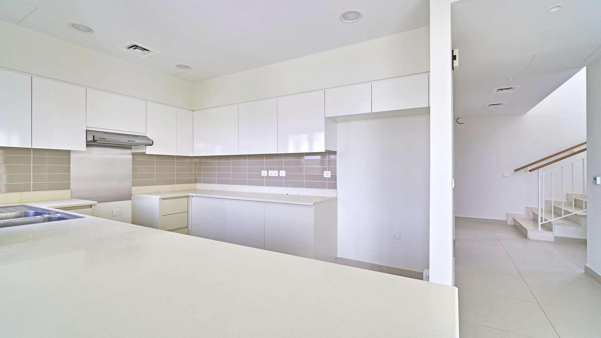Modern kitchen in 4-bedroom villa, Maple 2, Dubai Hills Estate, with sleek white cabinetry