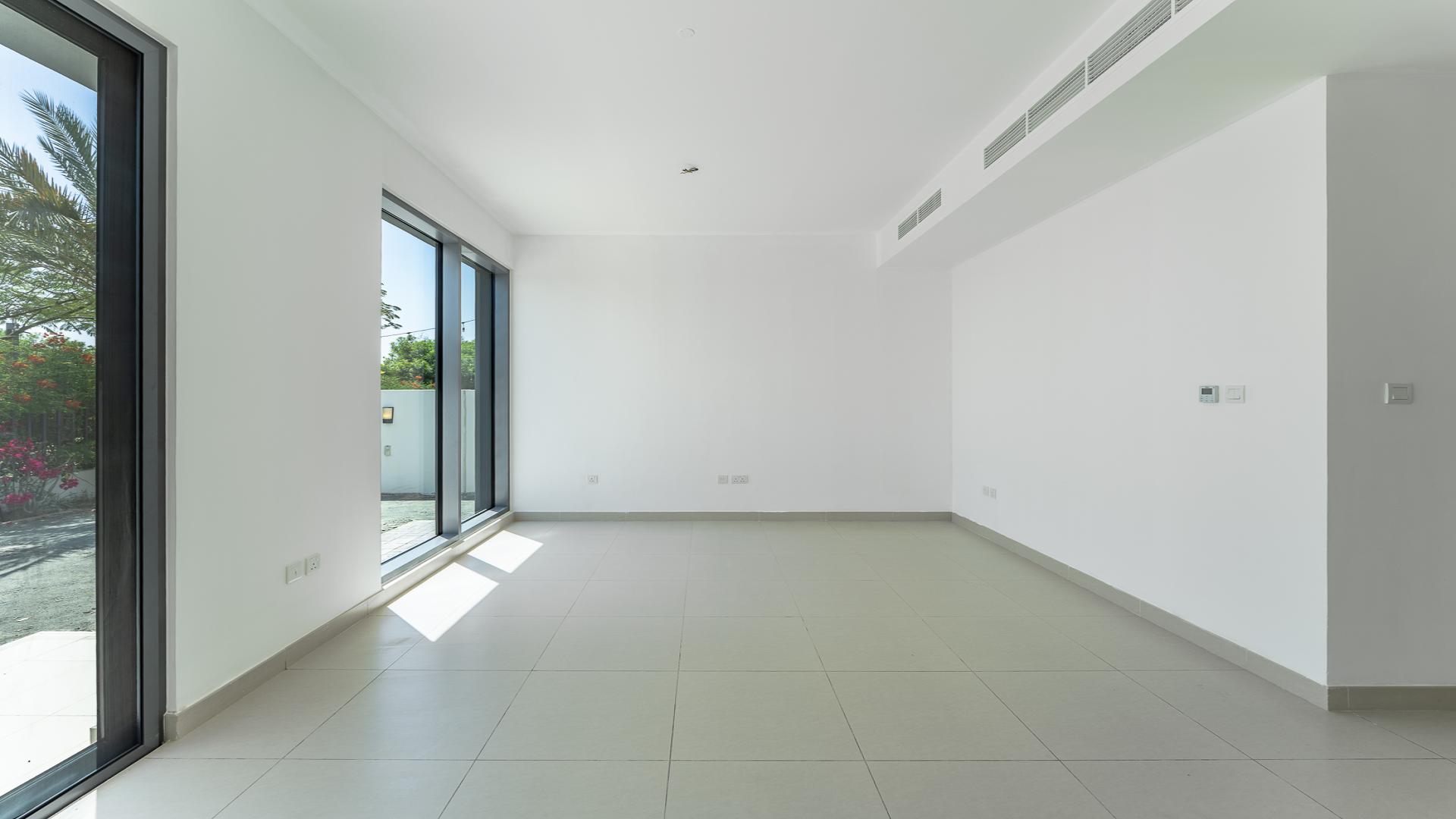 "Spacious villa exterior in Maple 3, Dubai Hills Estate, available for rent, 4 bedrooms.",Spacious living room with large windows in Dubai Hills Estate villa for rent