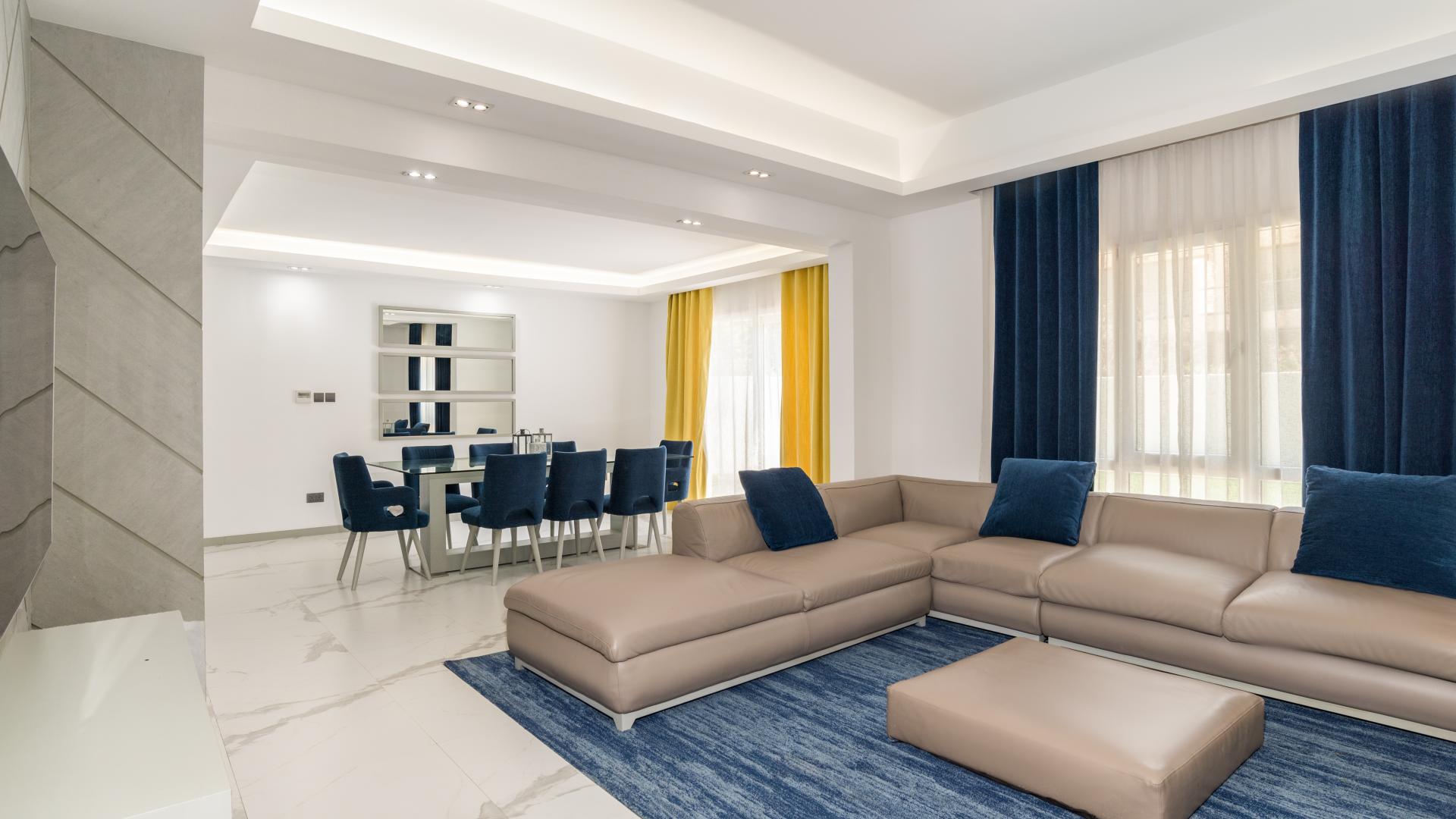 Elegant living area in upgraded Meadows 5 villa, featuring modern furnishings and spacious layout