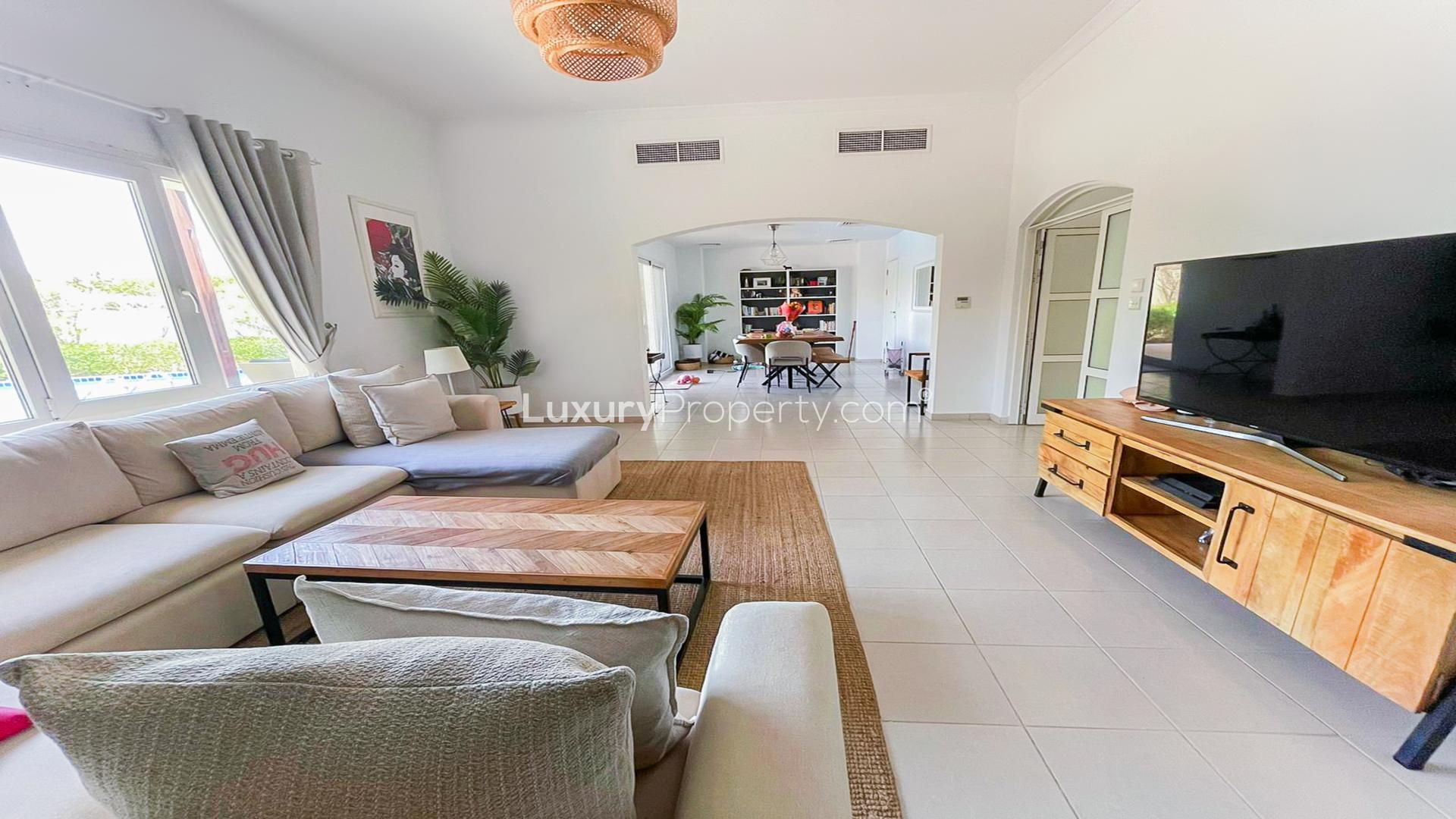 Spacious living room in Meadows 9 villa with modern decor and large windows