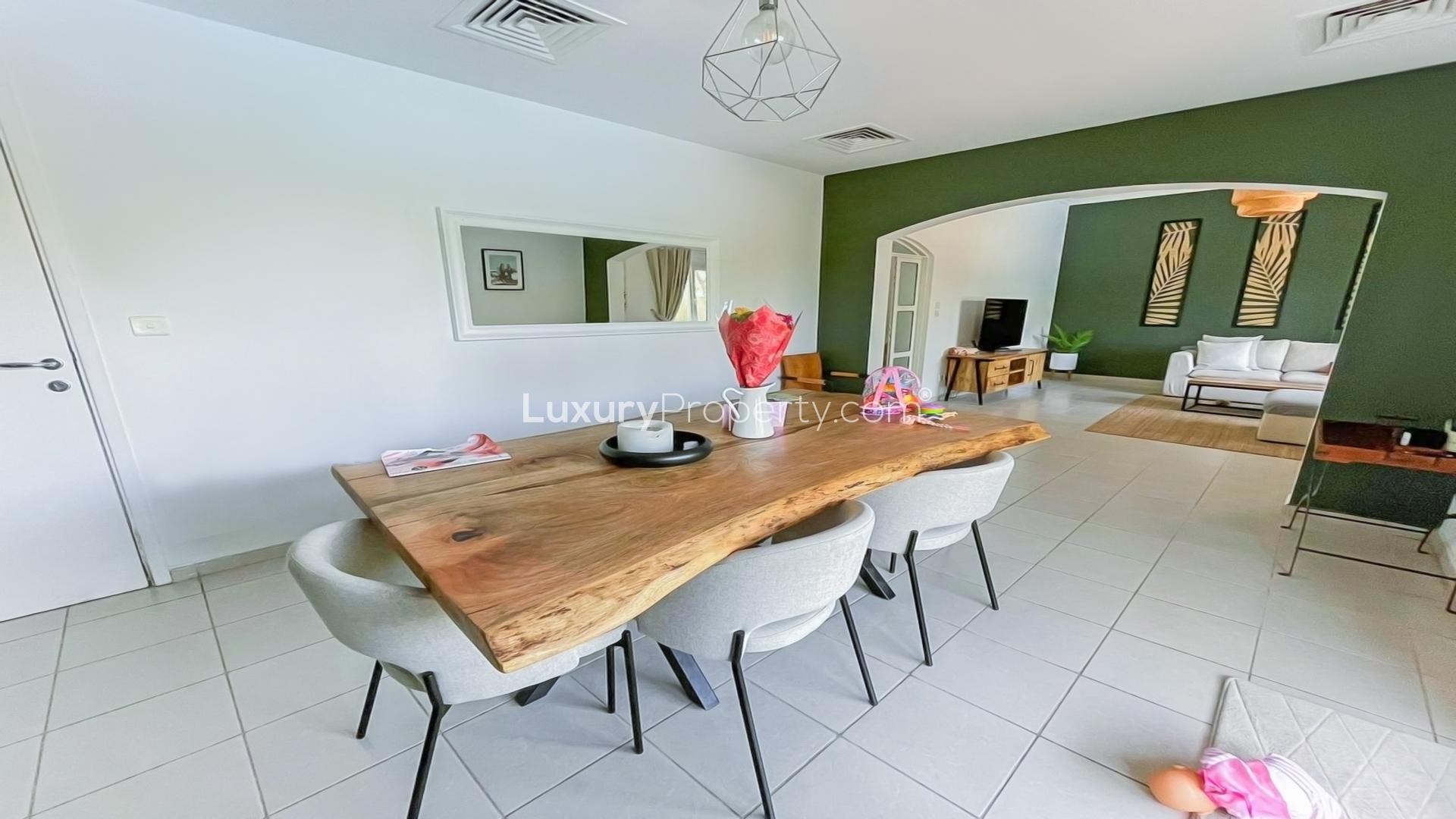 "Meadows 9 villa patio with private pool and seating area for rent.",Dining area and living room in Meadows 9 villa for rent, featuring modern decor