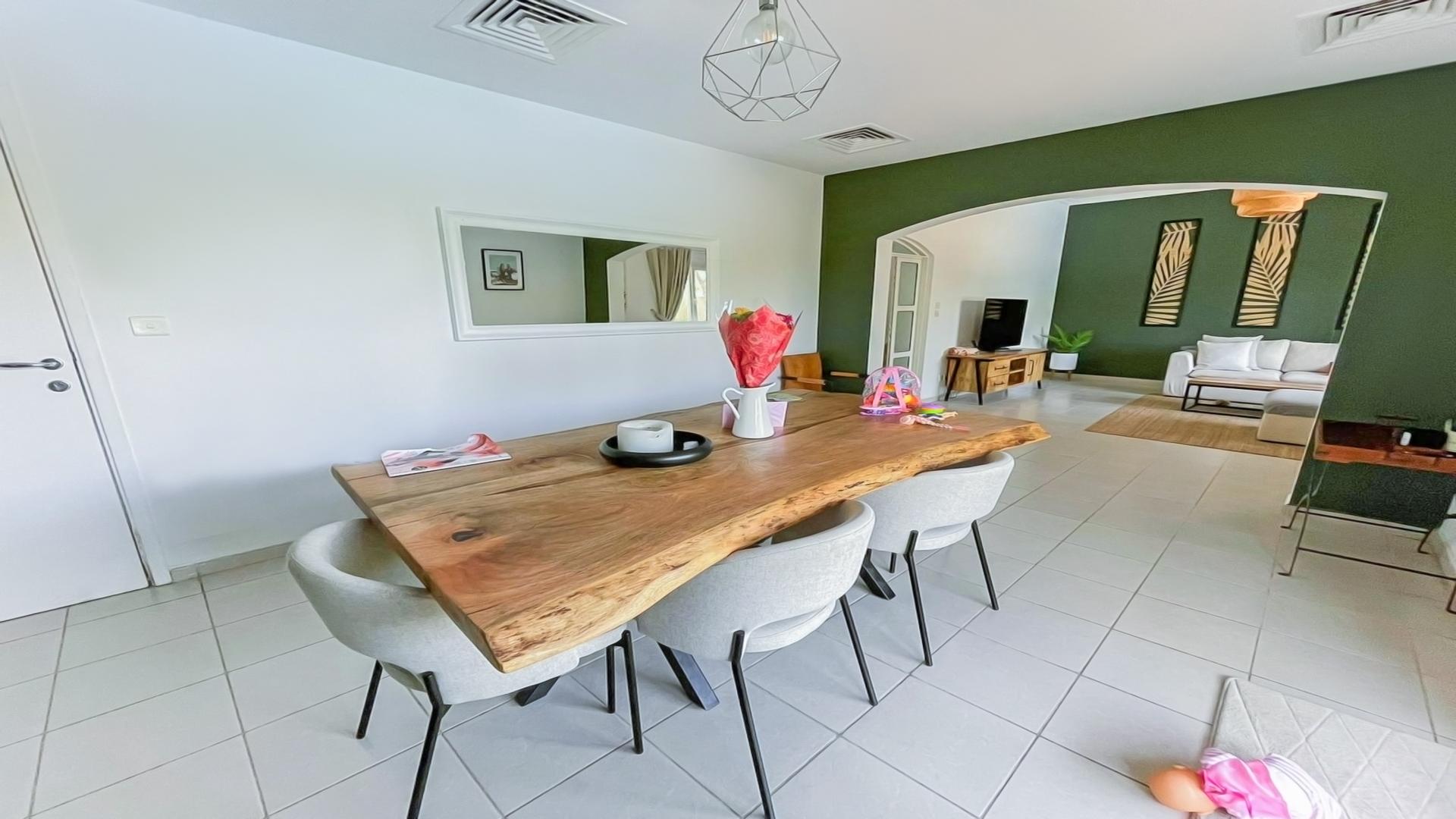 "Meadows 9 villa patio with private pool and seating area for rent.",Dining area and living room in Meadows 9 villa for rent, featuring modern decor