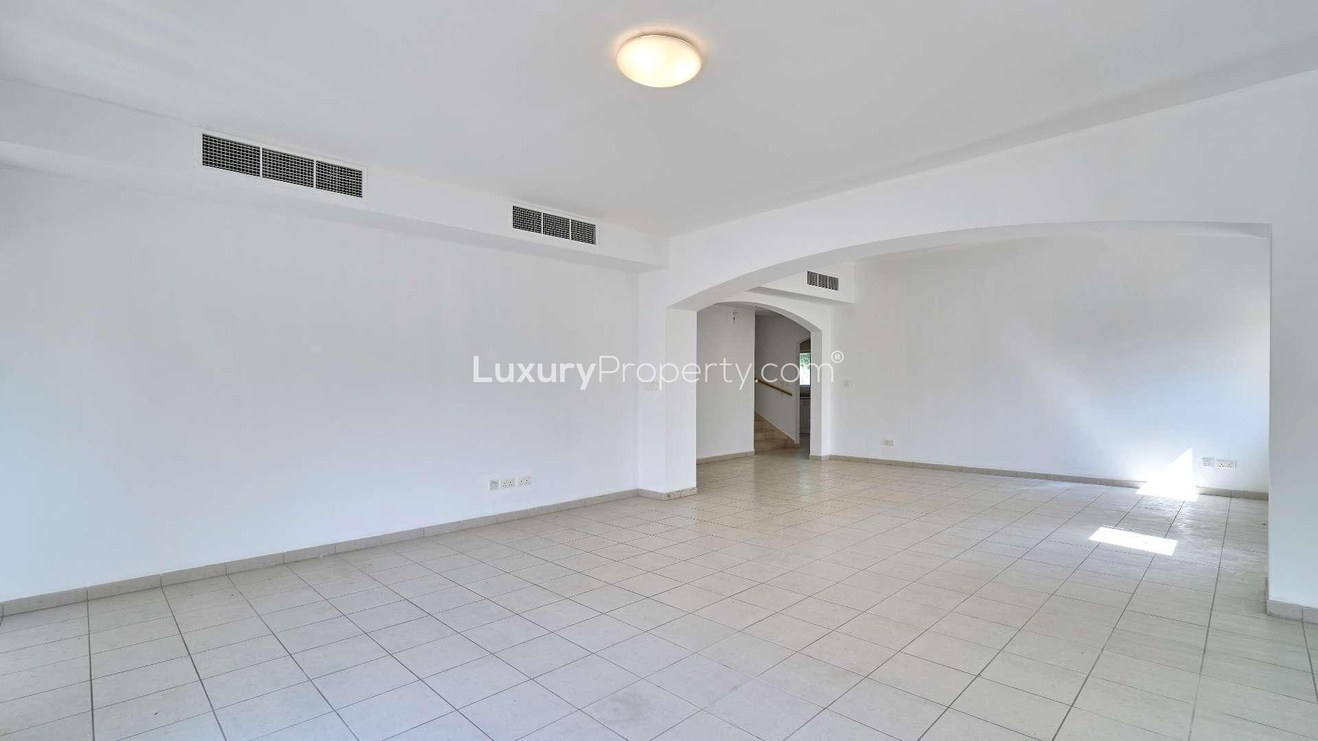 Spacious terrace in Meadows 1 villa for rent, surrounded by lush greenery