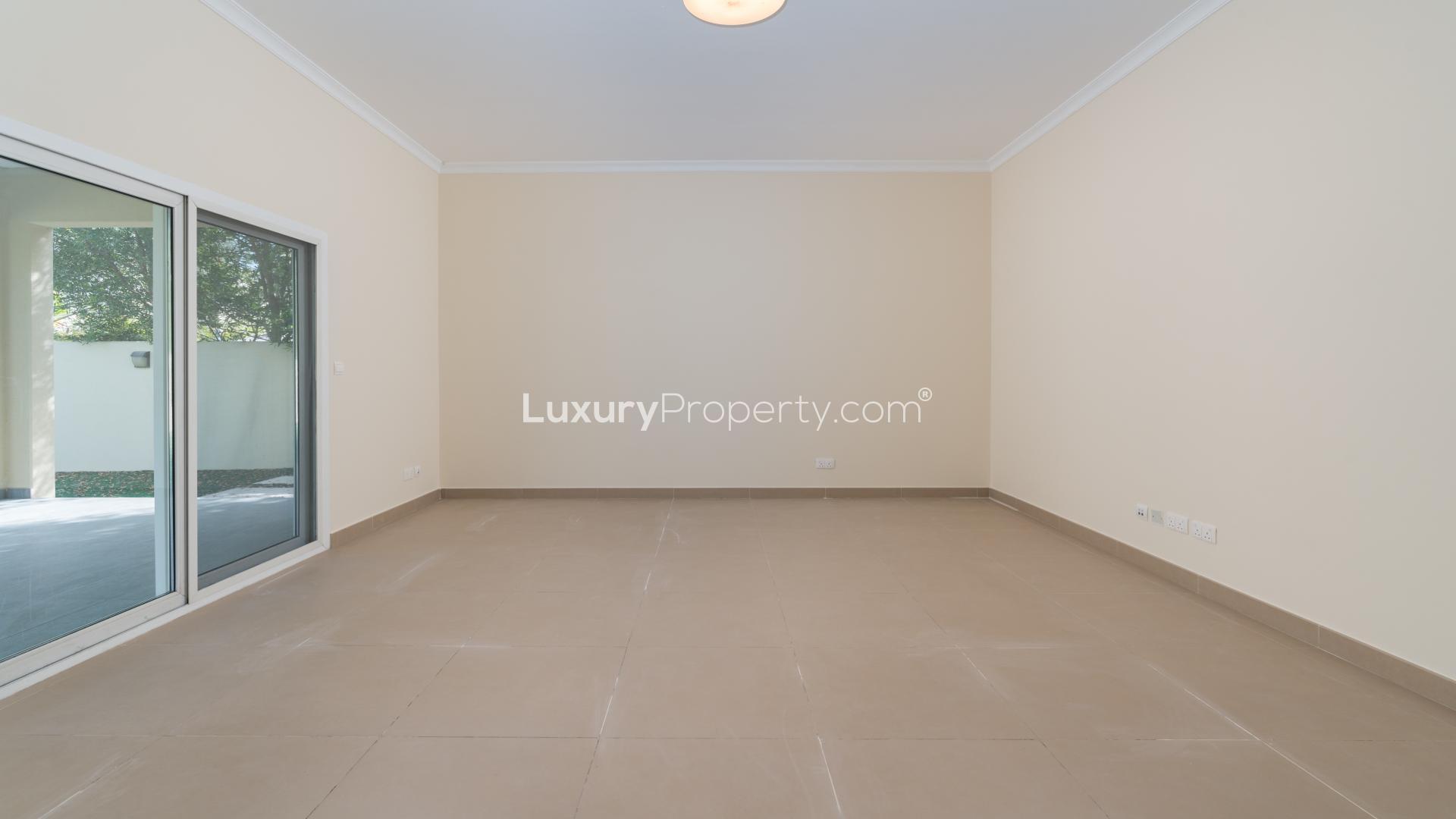"Spacious balcony view from luxurious 4-bedroom villa in The Meadows, Emirates Living.",Empty room with sliding glass doors in 4-bedroom villa, Meadows, Emirates Living