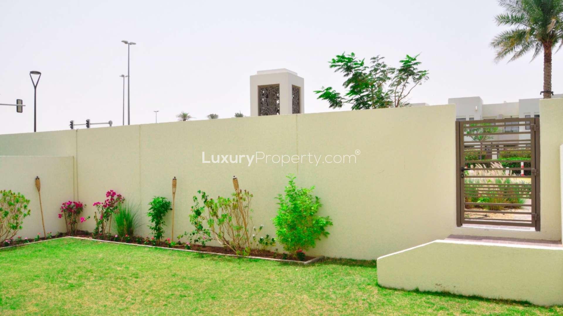 Single row villa exterior view in Mira Oasis 3, Reem community, with street and greenery.