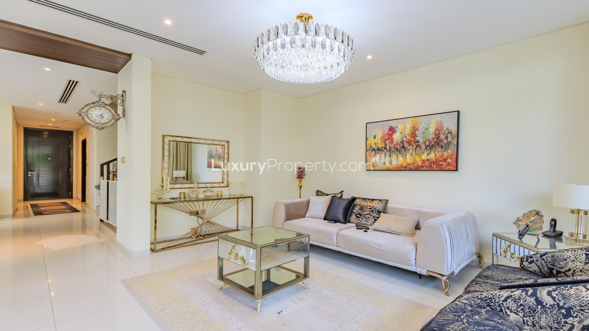 Charming villa outdoor space with seating and greenery in Damac Hills, Queens Meadow