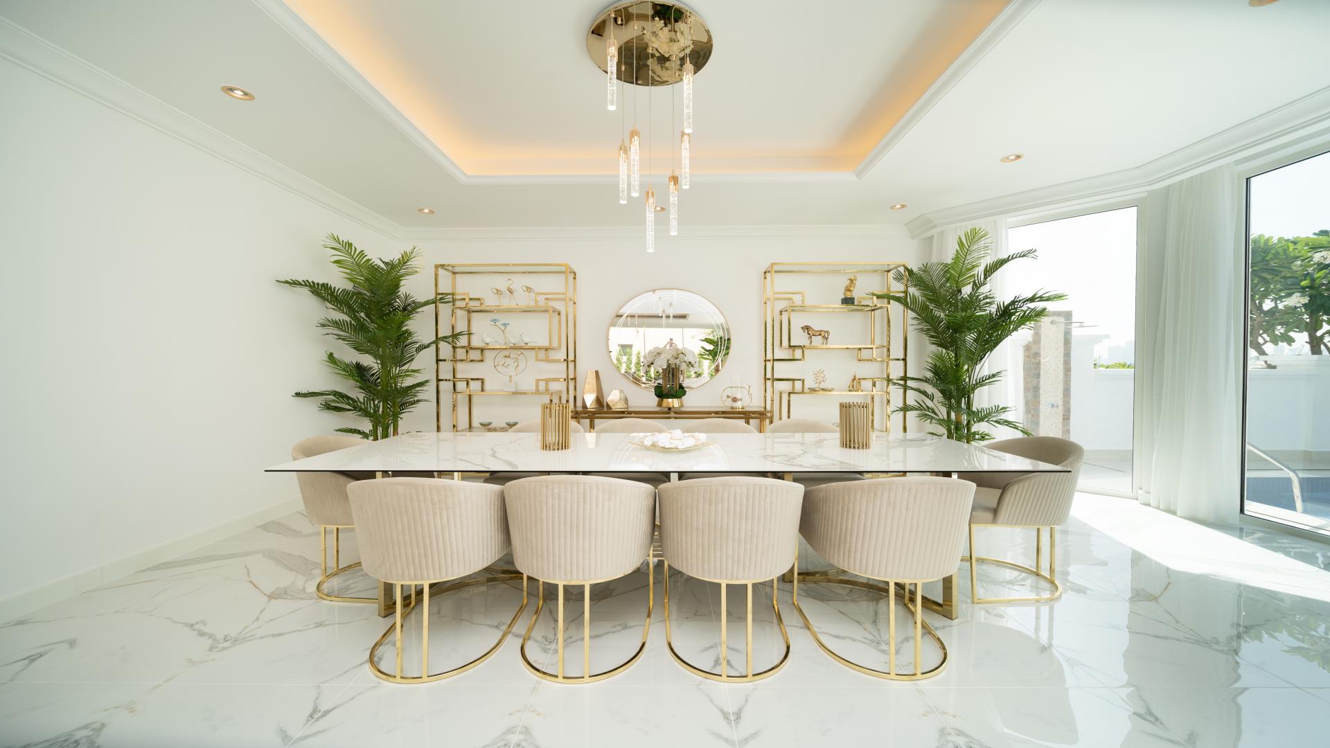 Luxurious living room in 5-bedroom villa, Palm Jumeirah, with elegant decor and garden view